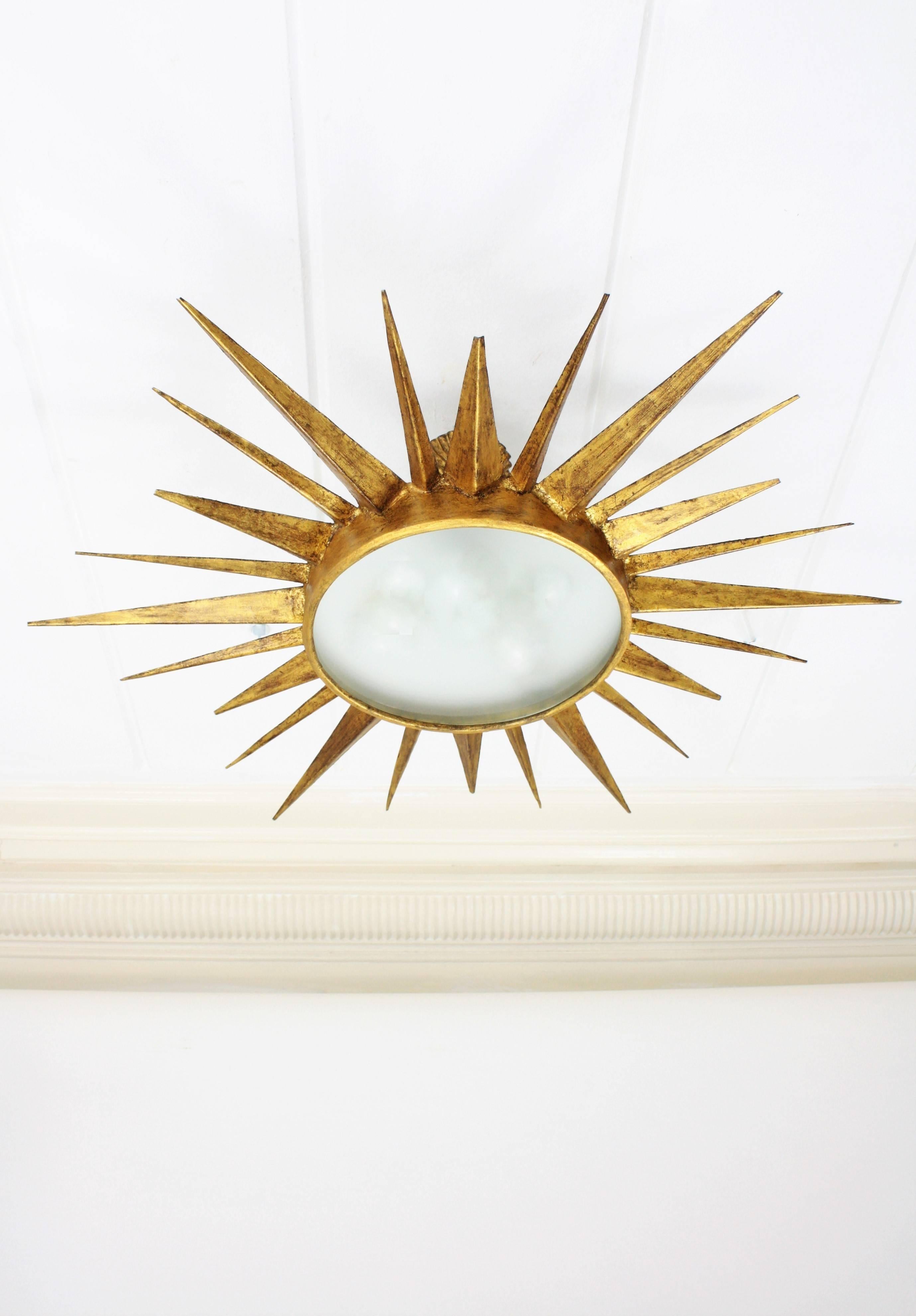 Mid-Century Modern Gilt Iron Sunburst Ceiling Light Fixture and Sunburst Mirror In Excellent Condition In Barcelona, ES