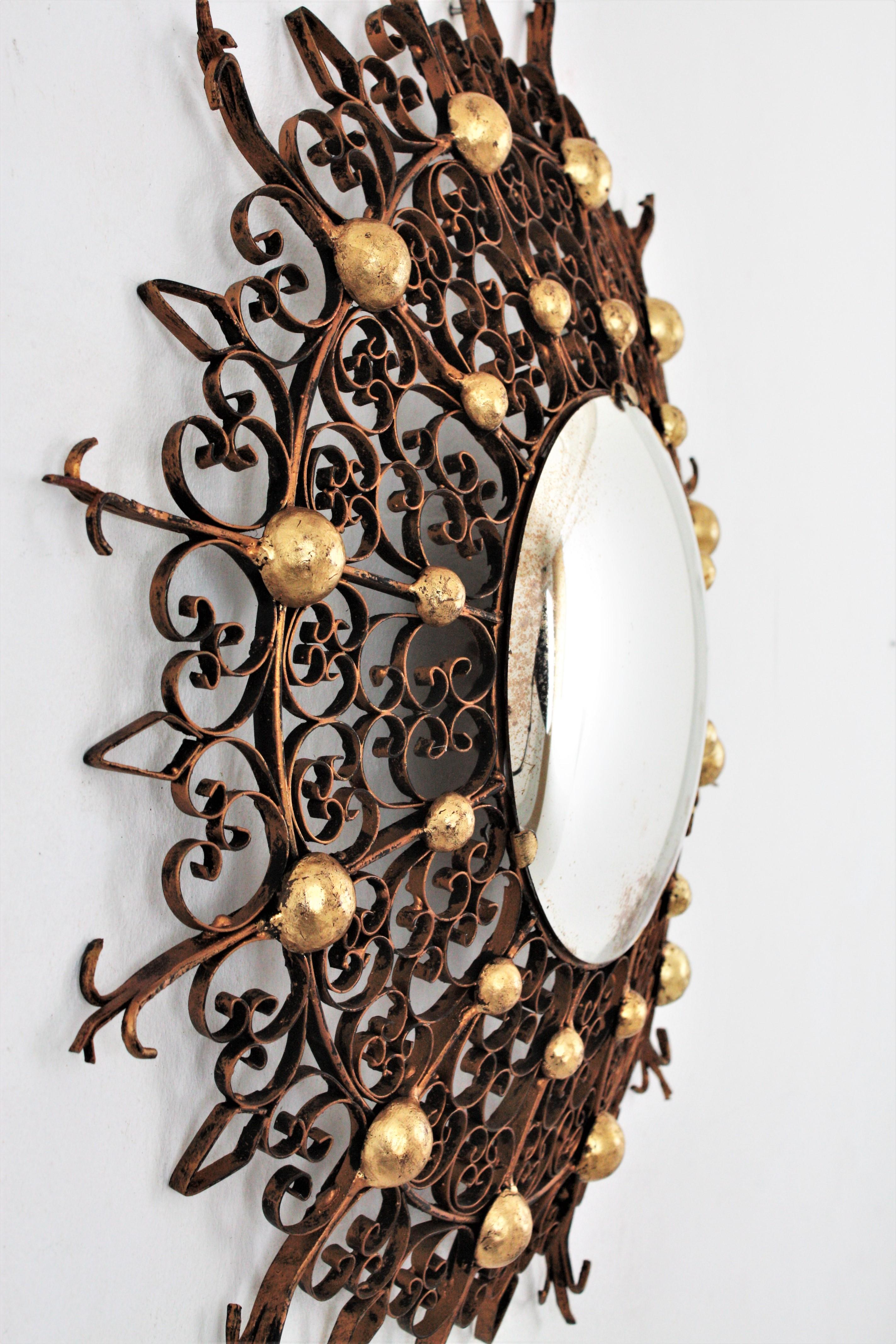 Gilt Sunburst Convex Mirror in Iron with Scrollwork Frame For Sale