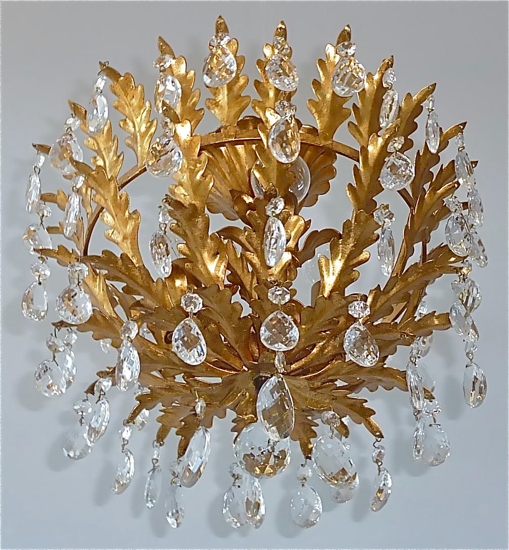 Fabulous Hollywood Regency gilt metal leaf basket flush mount chandelier with lots of Murano glass crystals made in Italy, circa 1950-1960. The beautiful hand-crafted Florentine basket light fixture with floral bobeches and lovely leaf decoration