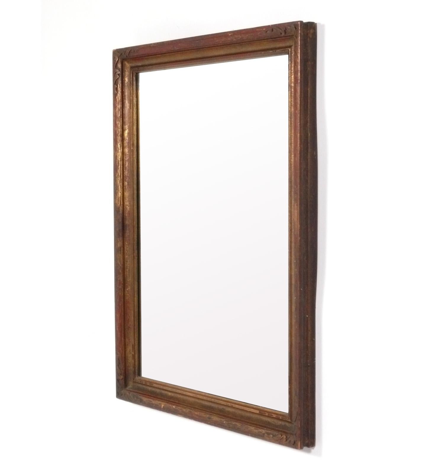 Gilt Italian mirror, recently removed from the famed Carlyle Hotel in NYC, originally from Italy, circa 1960s. It retains its original warm patina to both the gilt wood frame and the original mirror.