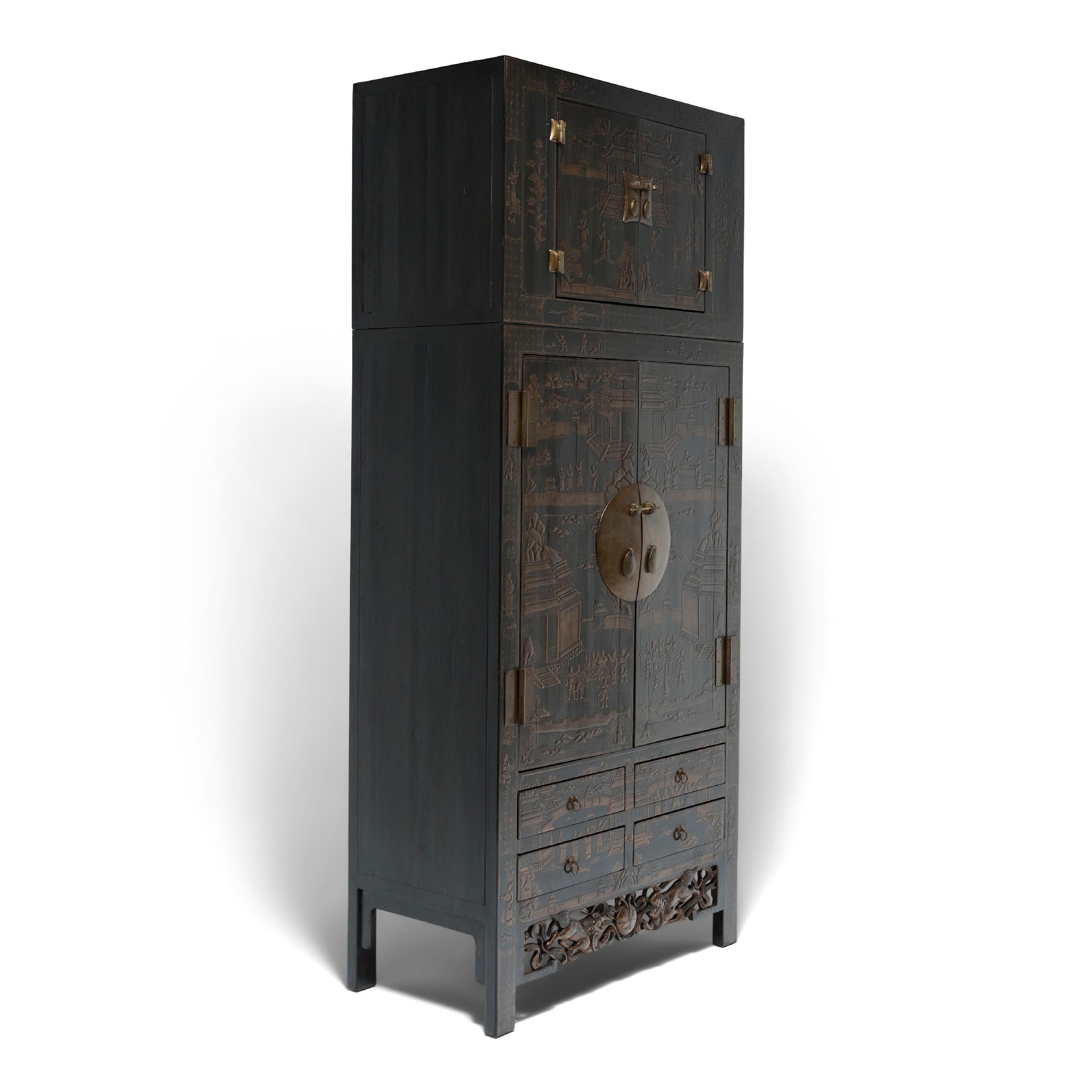 This striking gilt lacquer compound cabinet commands its surroundings with grand scale and lavish decoration. Seamlessly constructed of northern elm (yumu), the tall cabinet is actually comprised of two stacked storage compartments. The upper
