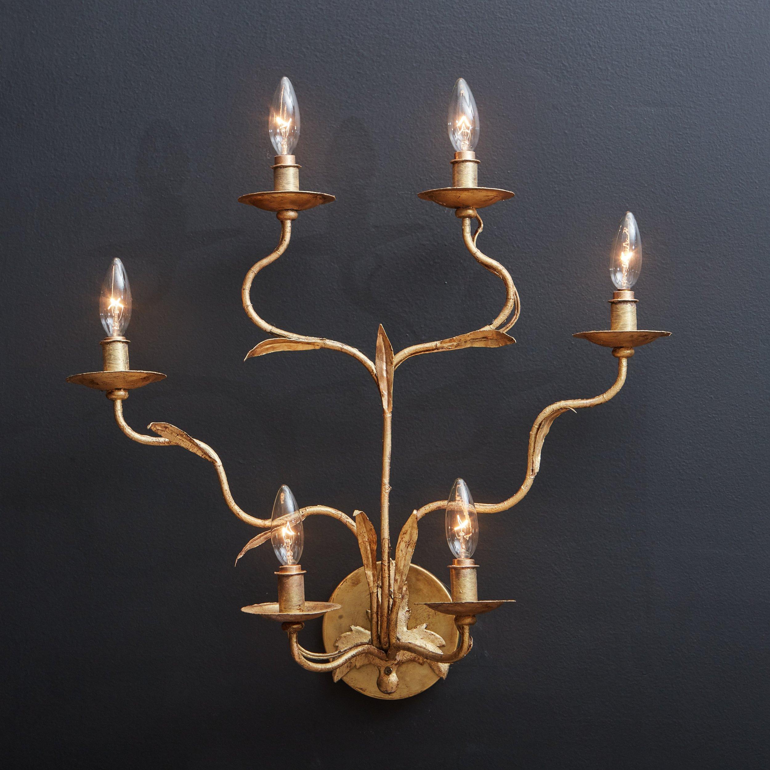 A 1960s Italian sconce featuring six curved arms with leaf detailing, reminiscent of a branch. Each arm has a bobeche and accepts one candelabra light bulb. This sconce is constructed with metal and has a stunning hand-applied gold leaf finish. It