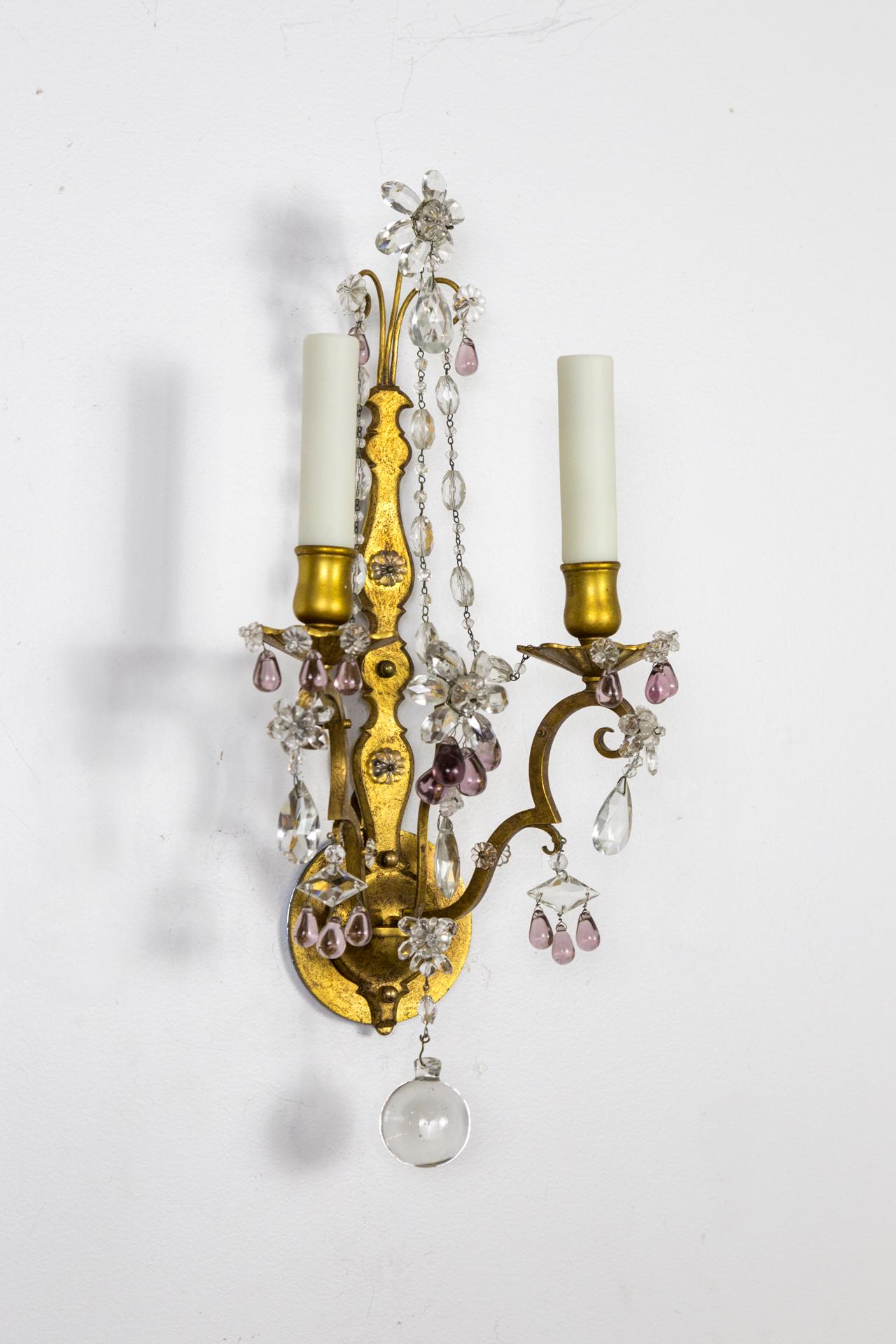 A pair of exquisite gilded brass, 2-light candlestick sconces with scroll details, variously shaped cut crystals in flower forms and clusters of amethyst crystal grapes, finished with a large crystal ball, circa 1920, newly wired, candelabra bulbs,