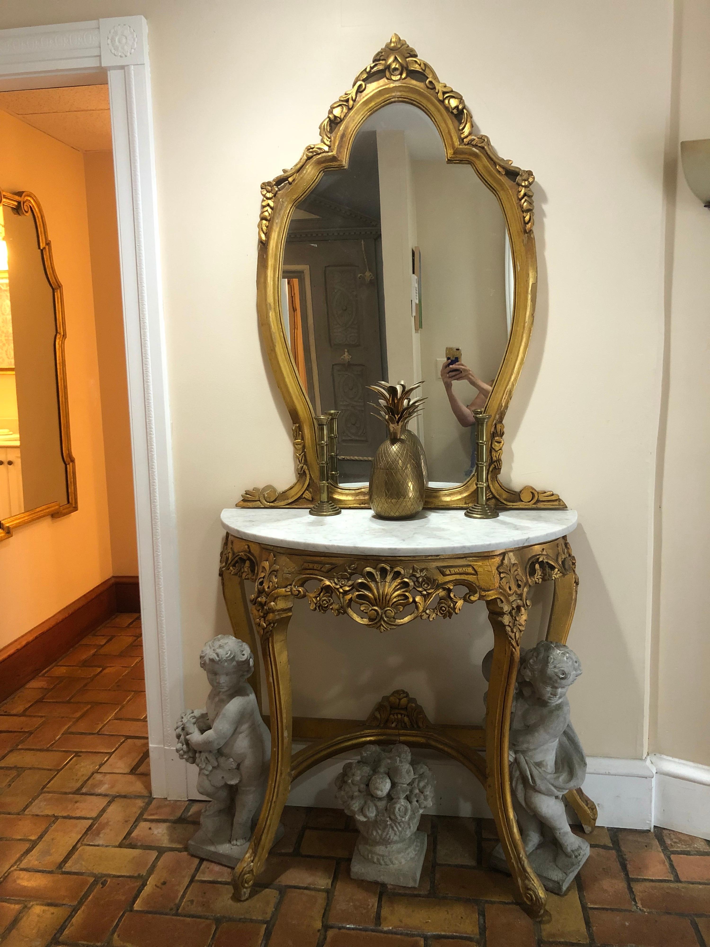 French gilt marble top demilune table with mirror. Two pieces. The mirror is hung on the wall and the base just rests on the marble. Open up your entryway with this elegant piece. The mirror alone measures 46