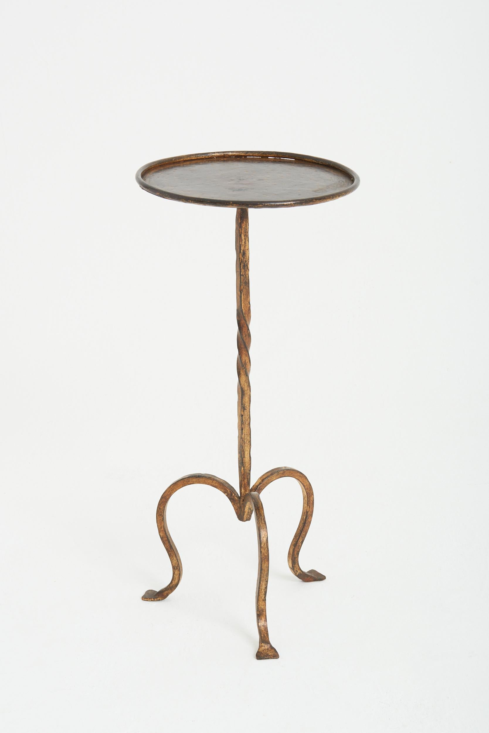 A gilt wrought iron martini table
Spain, third quarter of the 20th Century
61 cm high by 28 cm diameter
