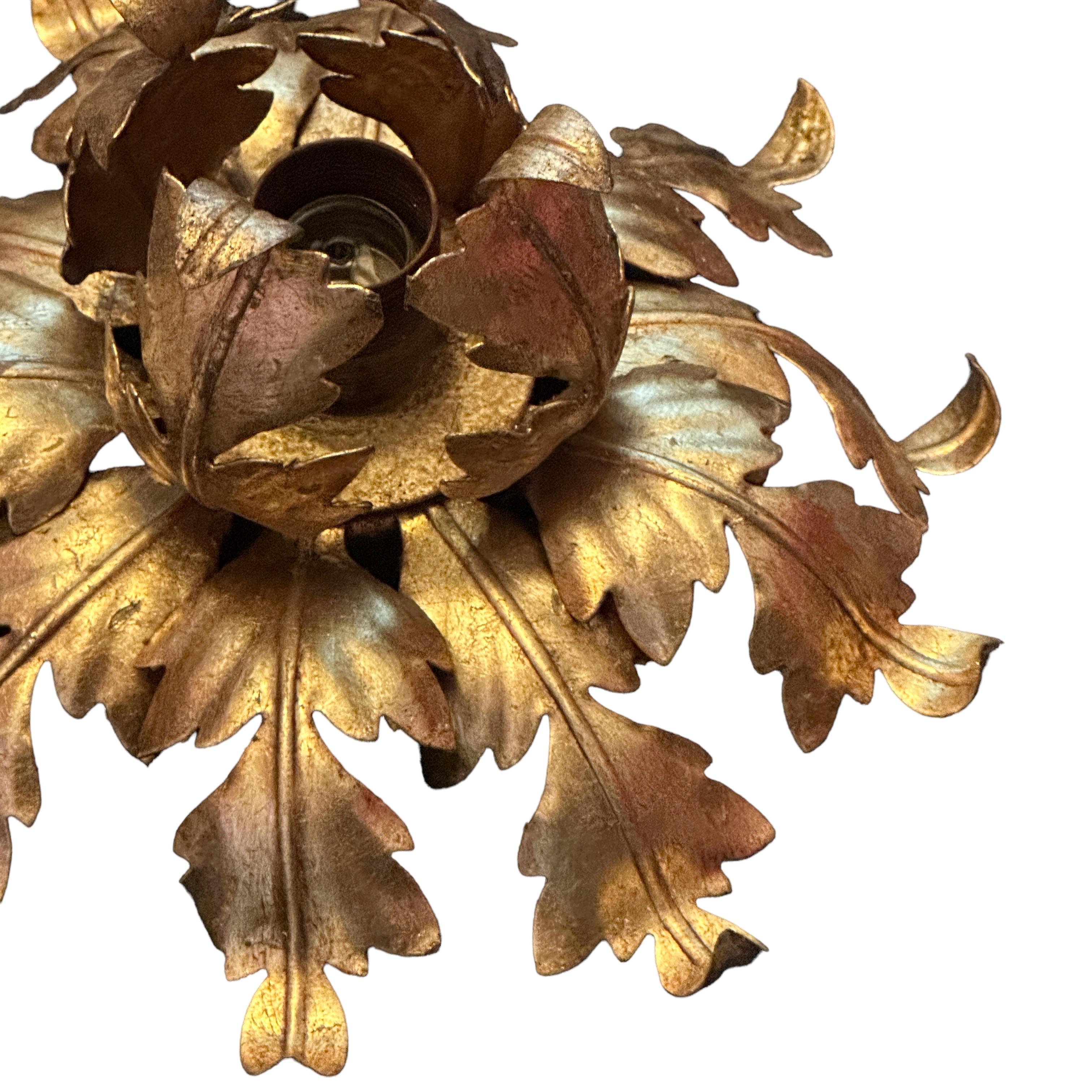 Add a touch of opulence to your home with this charming flush mount. Perfect gilt metal leafs to enhance any chic or eclectic home. We'd love to see it hanging in an entryway as a charming welcome home. Built in the 1960s, attributed to Banci