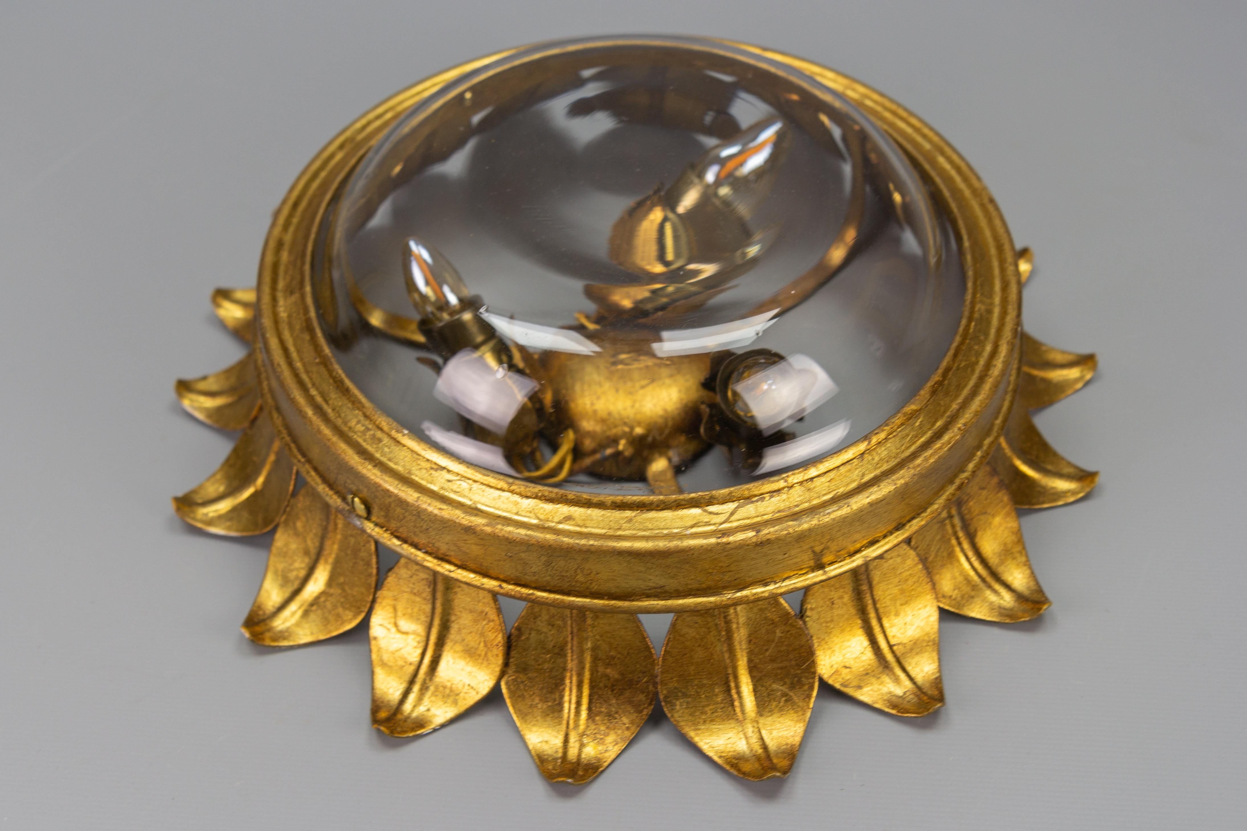 Hollywood Regency Gilt Metal and Clear Glass Sunburst Shaped Flush Mount or Wall Light, 1950s For Sale