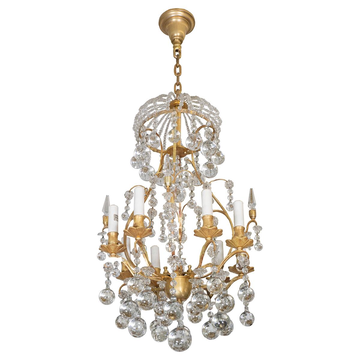 Gilt metal finish chandelier featuring various styles of crystal drop elements and cast flower bobeches.