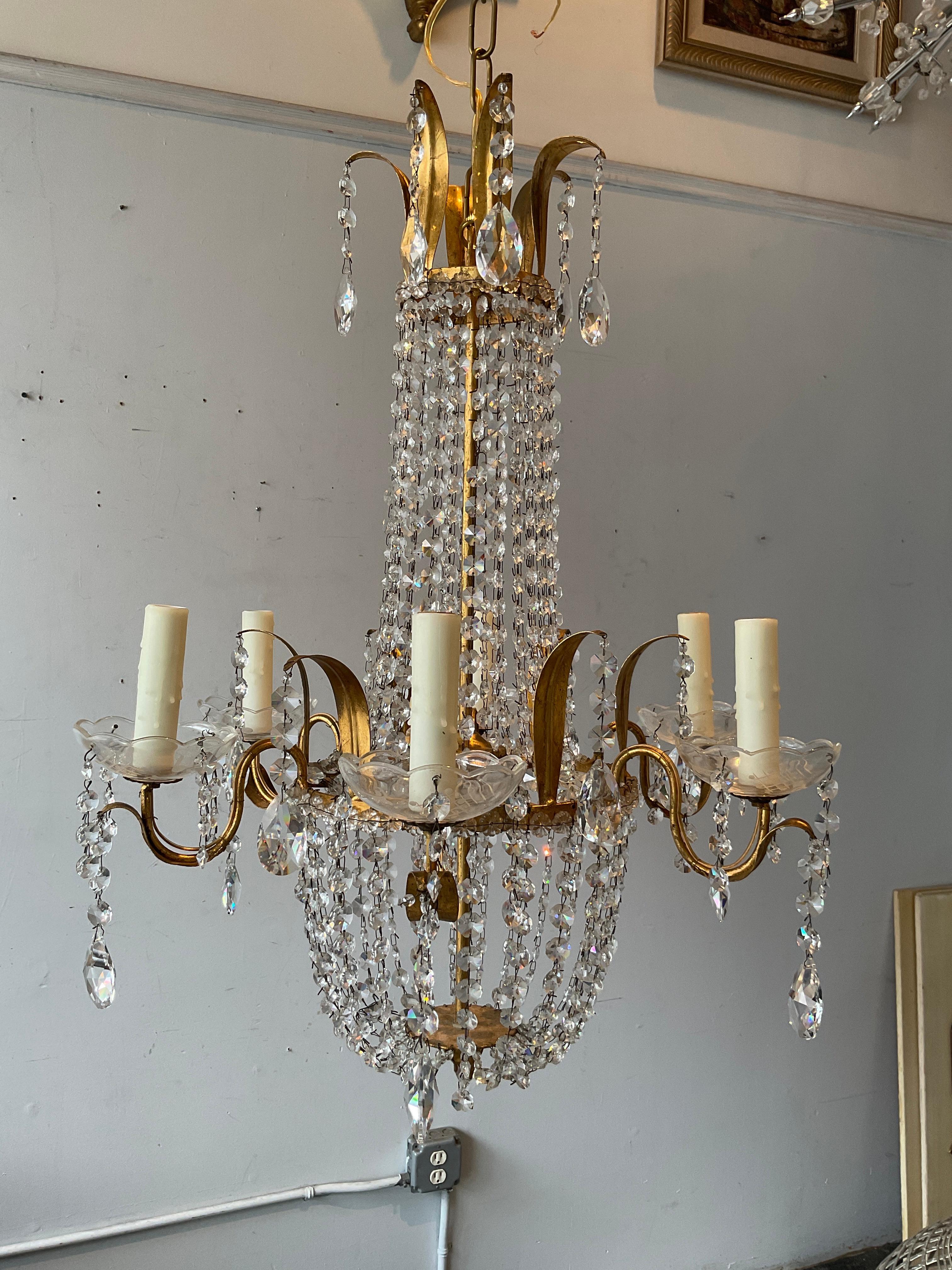 Gilt metal Regency style chandelier.
Has original wiring.Needs rewiring.