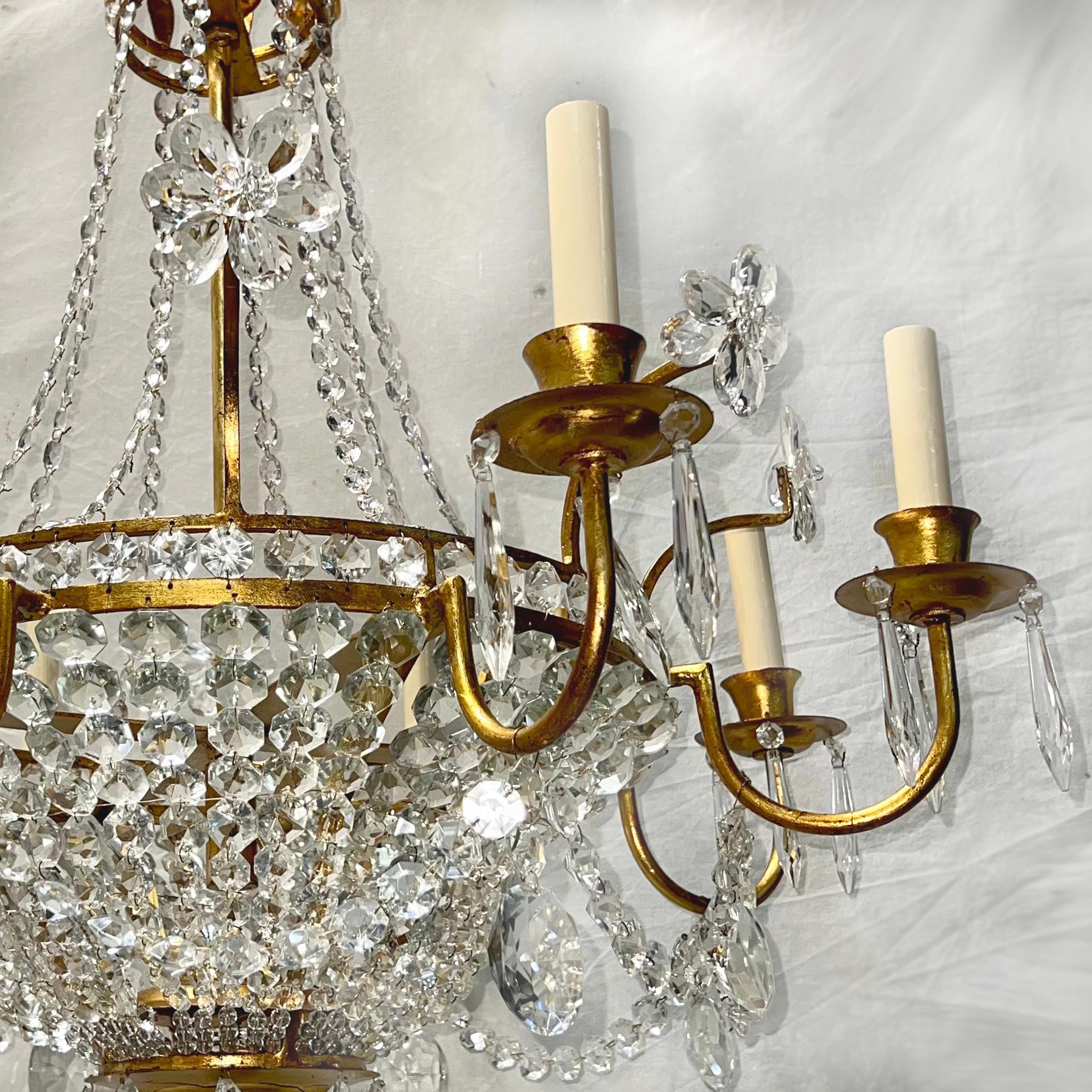 A French circa 1940's gilt metal basket shaped eight-light chandelier with original gilt finish, with crystal body, pendants and flowers.

Measurements:
Drop: 33
