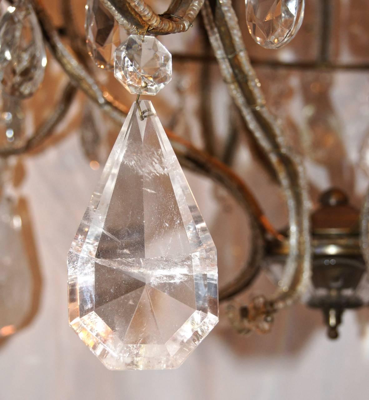 A circa 1900 Italian eight-arm gilt metal and beaded crystal chandelier with rock crystal pendants.

Measurements:
Minimum drop 35