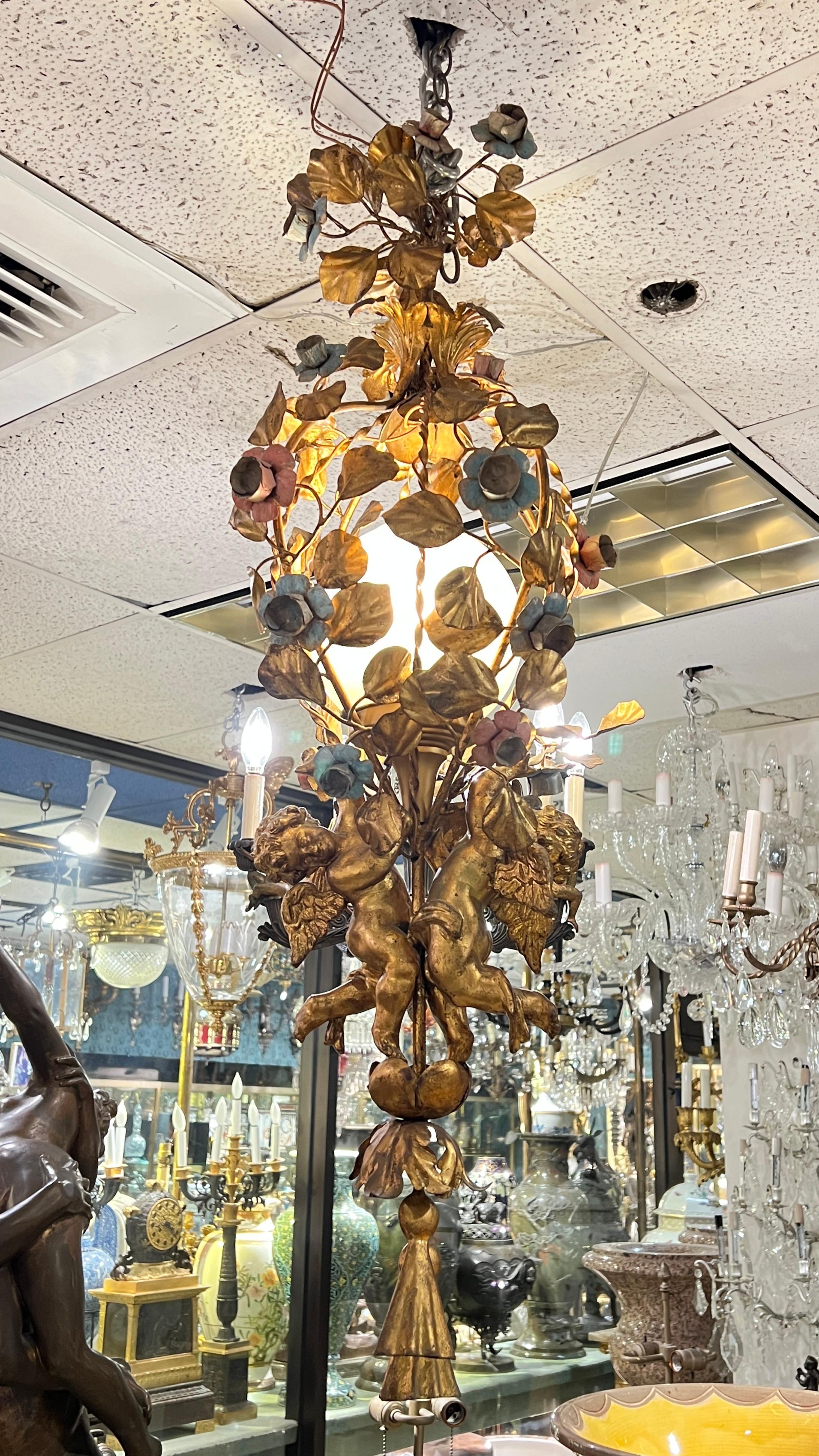 Very nice quality French mid century gilt metal and tole cherub motif chandelier with polychrome painted flowers, working and ready to hang and install.