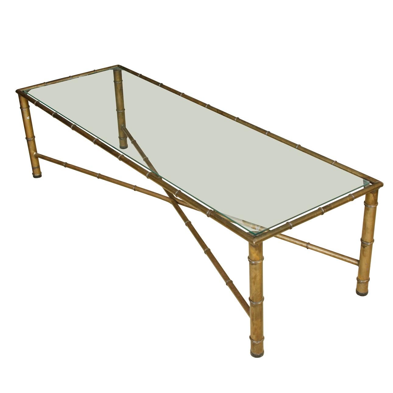 Gilt metal bamboo long rectangular glass top coffee table with X-stretcher.