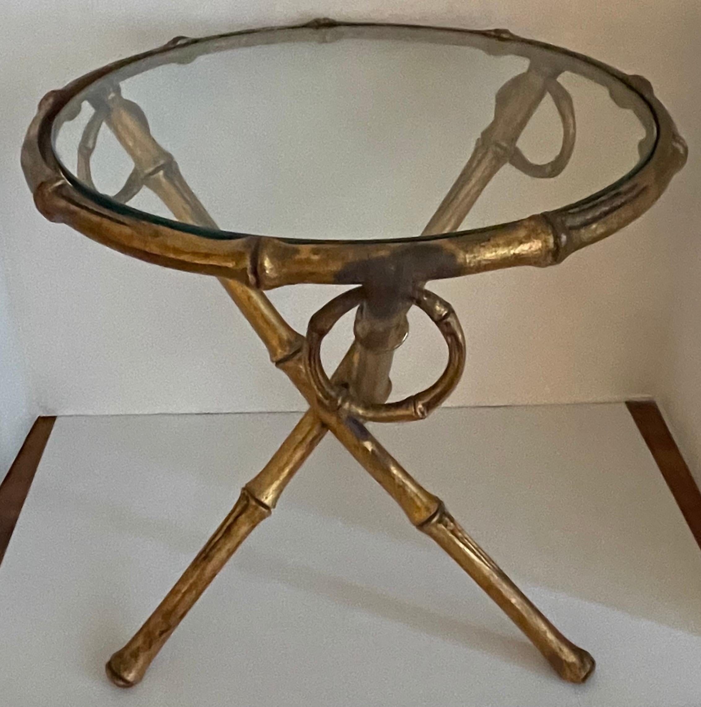 1960s gilt metal faux bamboo tripod style round accent or side table. Inset clear beveled glass top.