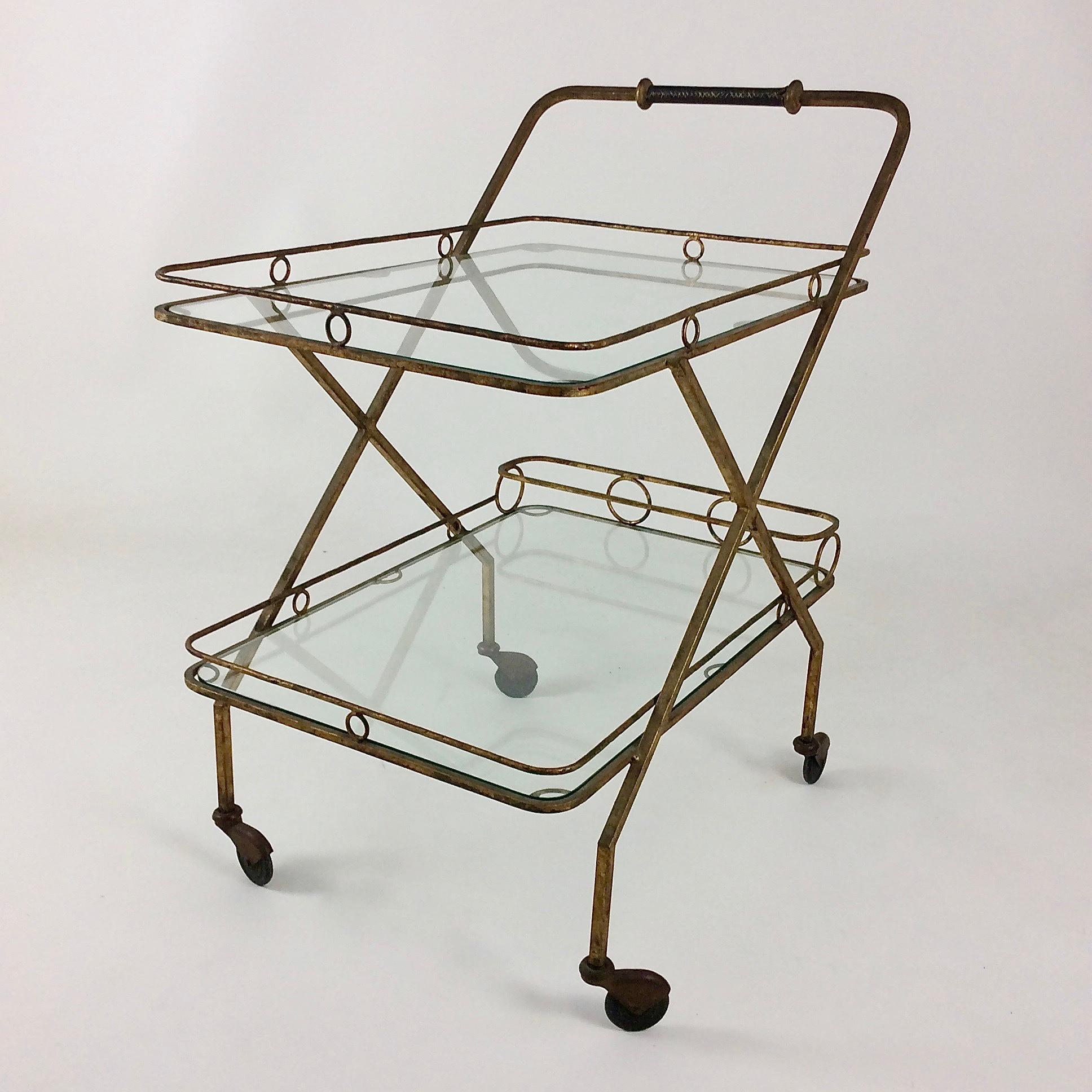 Nice bar cart, circa 1960, France
Gilt metal, one bottle holder and two glass shelves.
Black leather handle.
Dimensions: 81 cm H, 71 cm W, 48 cm D.
Original condition.
All purchases are covered by our Buyer Protection Guarantee.
This item can be