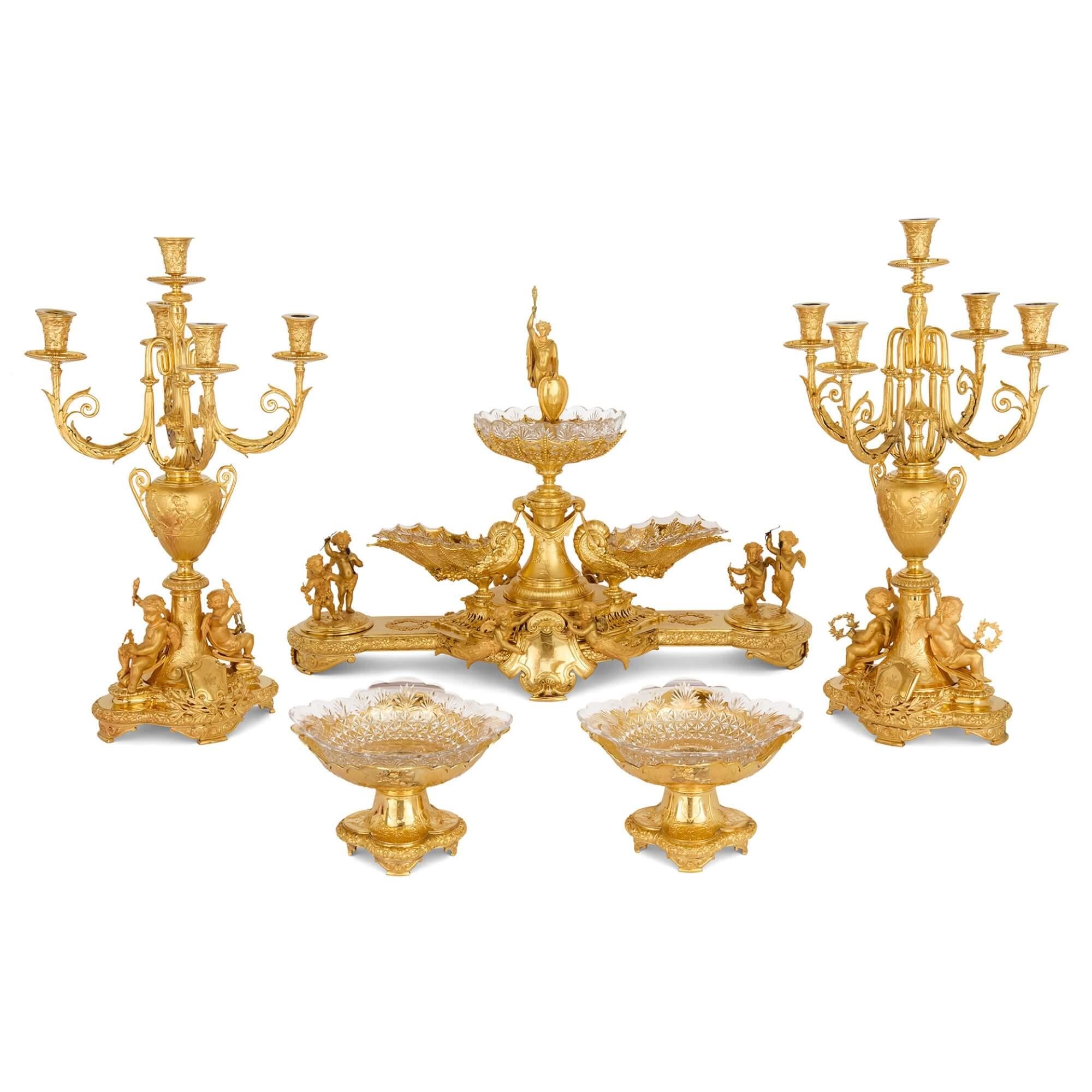 Gilt metal centrepiece suite for the Duke of Sparta by Elkington & Co.
English, Late 19th Century 
Centrepiece: Height 58cm, width 81cm, depth 35cm
Candelabra: Height 66cm, diameter 40cm

Crafted in the late 19th century as a wedding gift for the