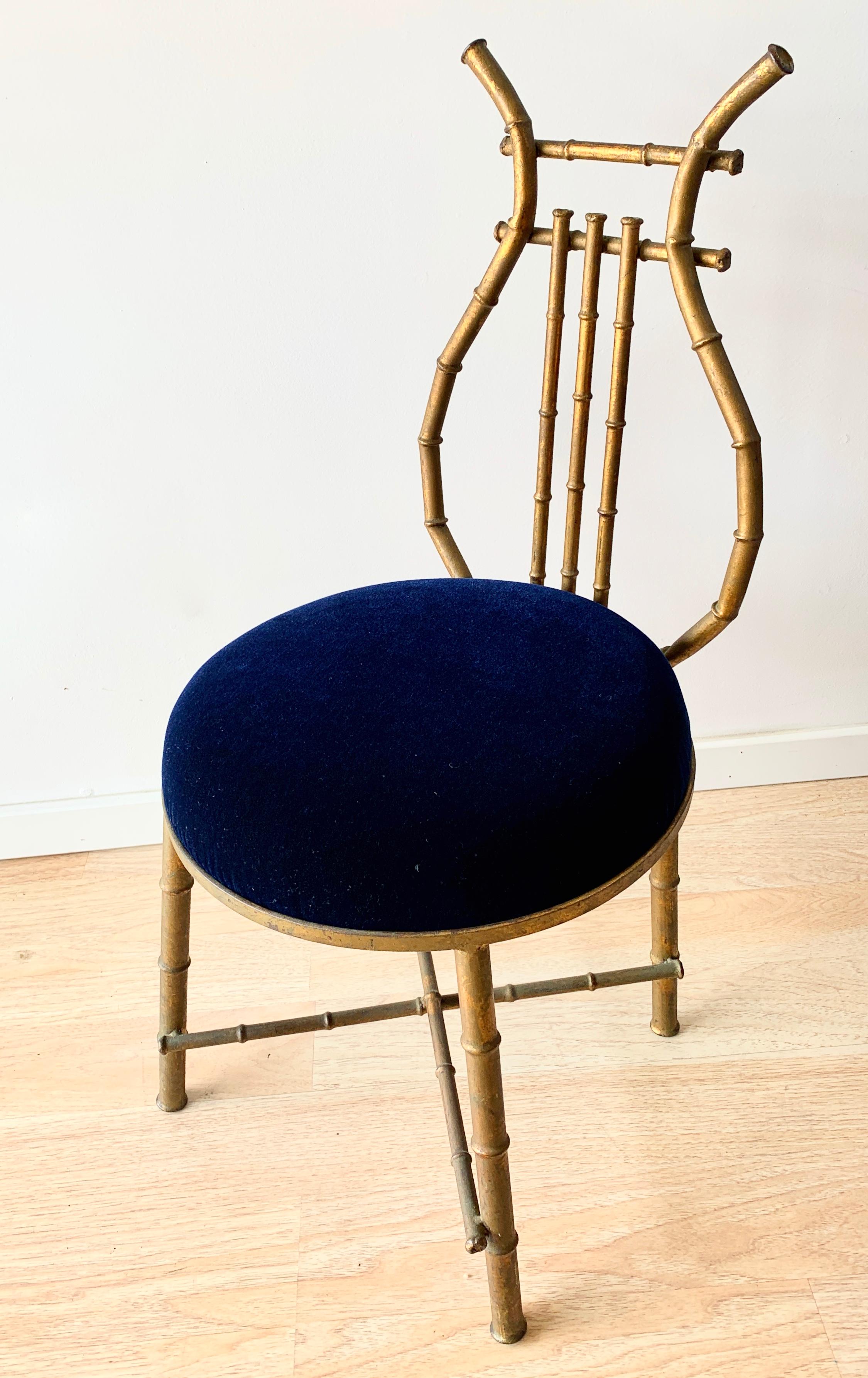 A unique chair with a lire shaped back and upholstered in cerulean blue mohair. A small vanity sized chair, light weight and perfectly suited for a dressing room, music room or childs space.