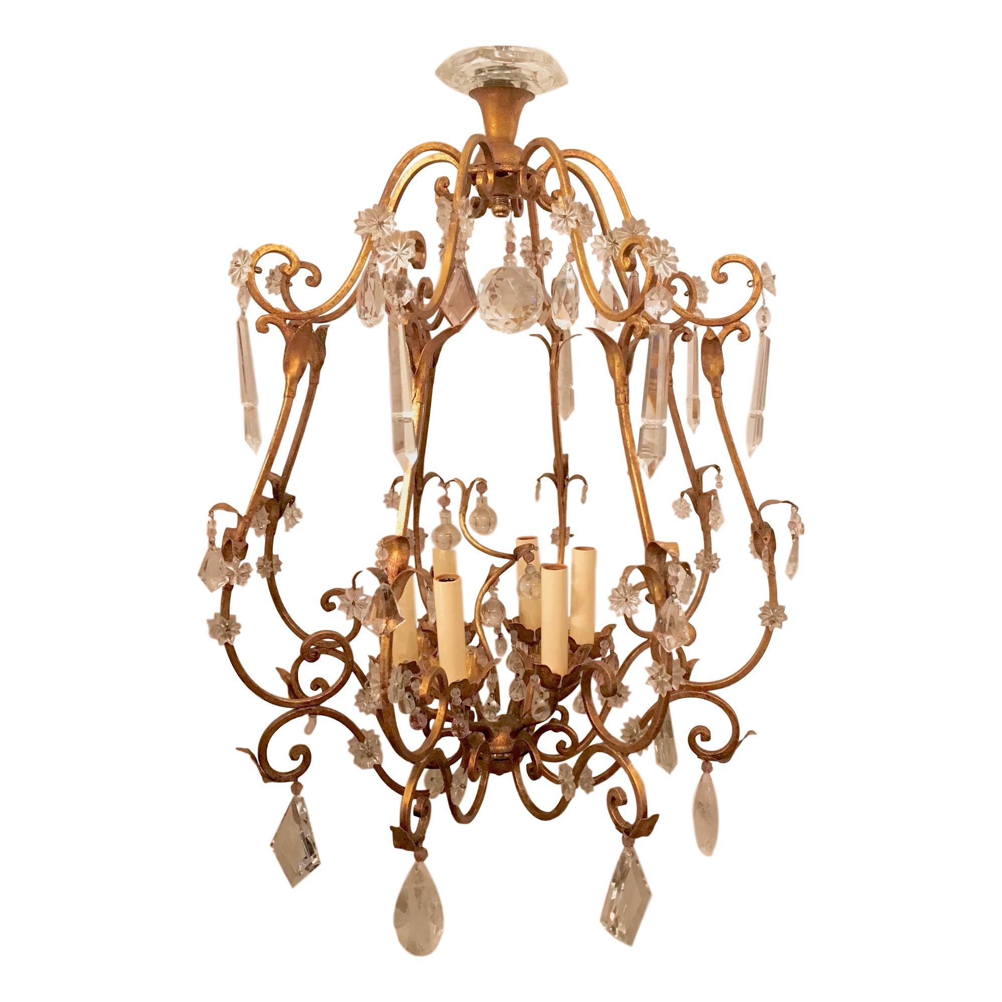 A circa 1920’s French gilt metal chandelier with rock crystal pendants and six interior candelabra lights.

Measurements:
Height (minimum drop): 36