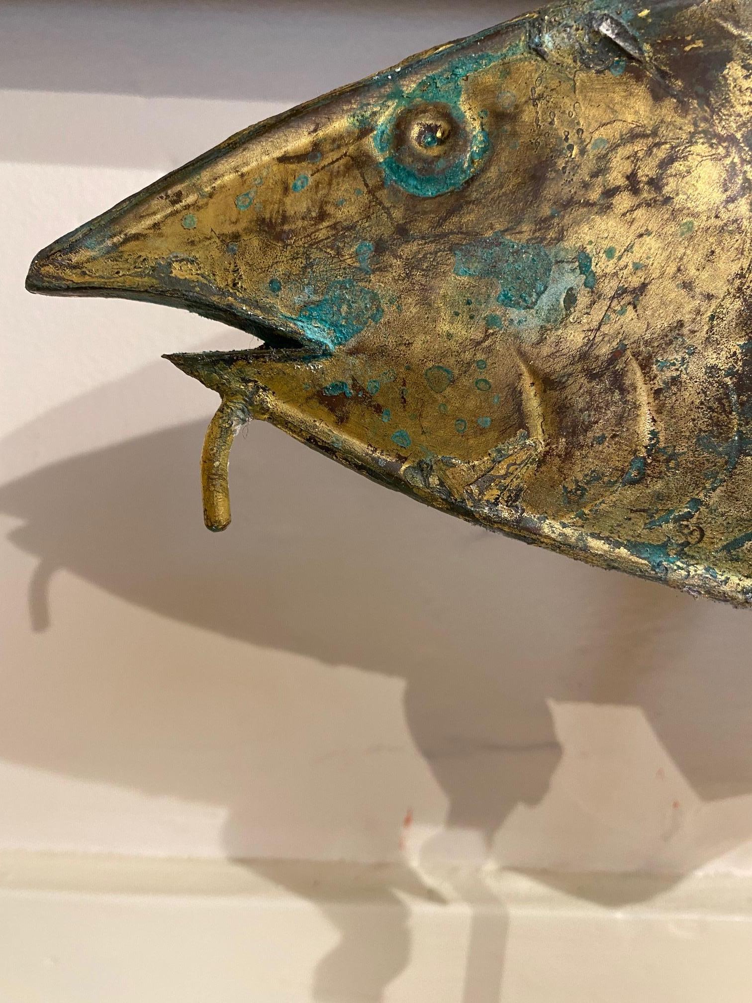 Antique gilded metal codfish weather vane, circa 1910, cast and welded sheet metal, likely zinc, forming a three dimensional embossed hollow codfish with three proud dorsal fins, large scales and chin barbel, in what looks like the original gilt