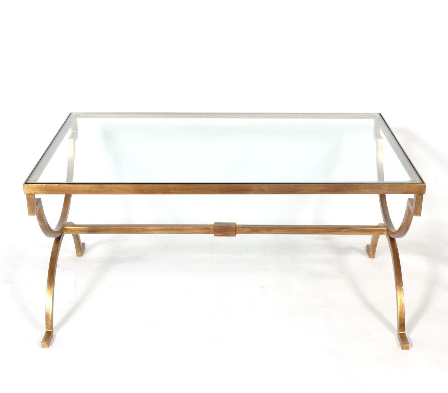 Gilt metal coffee table, American, circa 2000s. Based on a 1930s French Art Deco design, this table is constructed of gilt metal with an inset glass top.