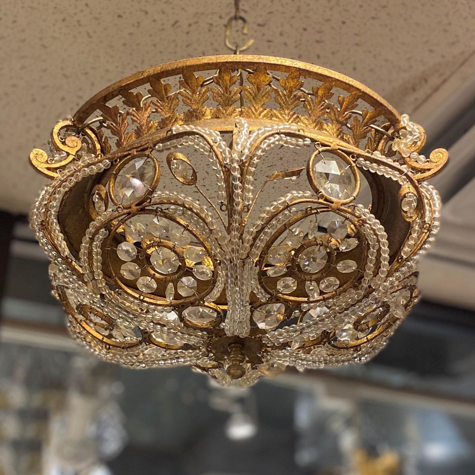 Gilt metal and crystal chandelier in Maison Baguès style from Quoizel.