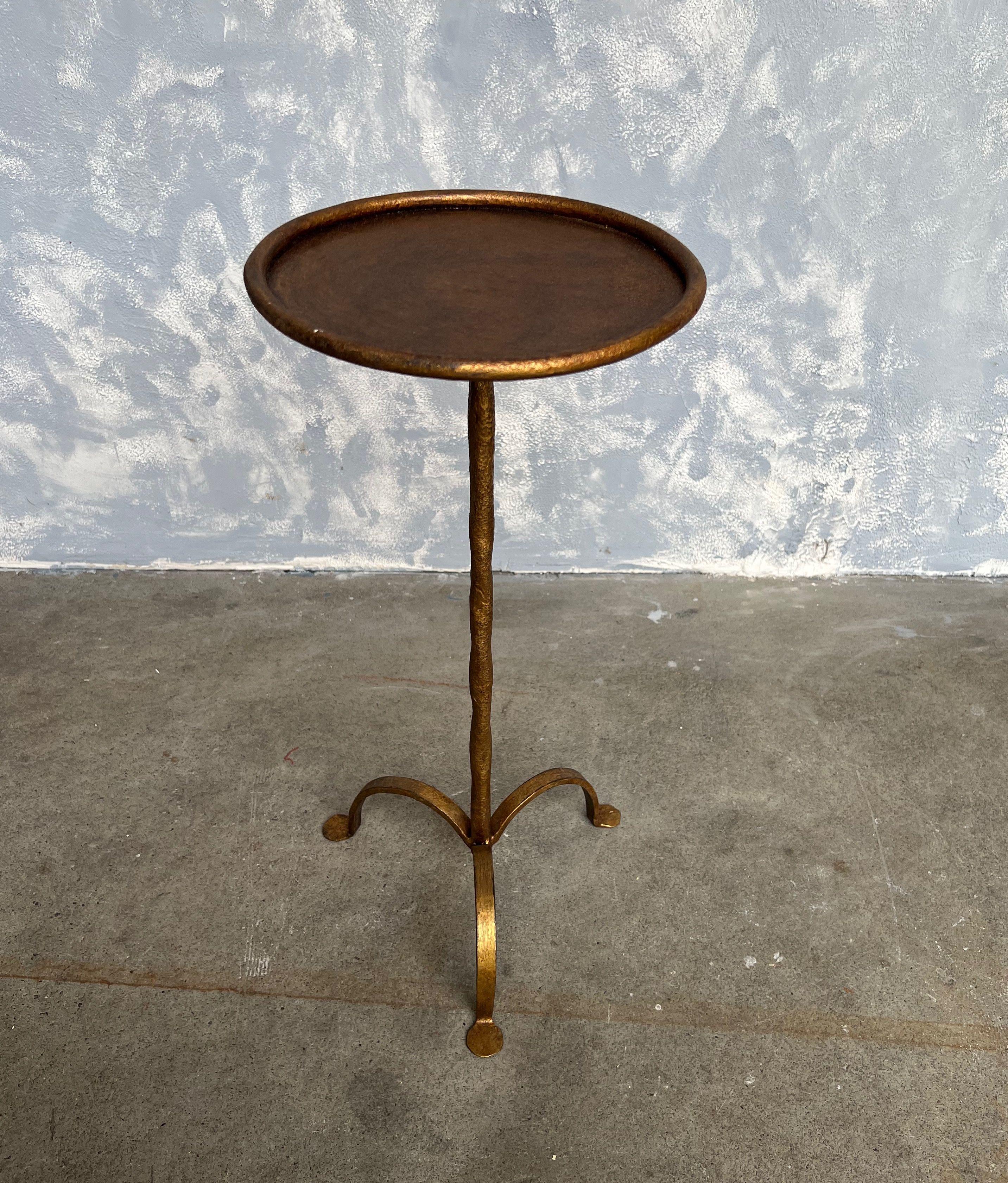 Small gilt iron and metal end table with a hand forged stem. Perfect for a drink, it can easily be moved around as needed. The original finish shows several under layers of black and red making for a rich patina.

Spanish, 1950s. Very good vintage