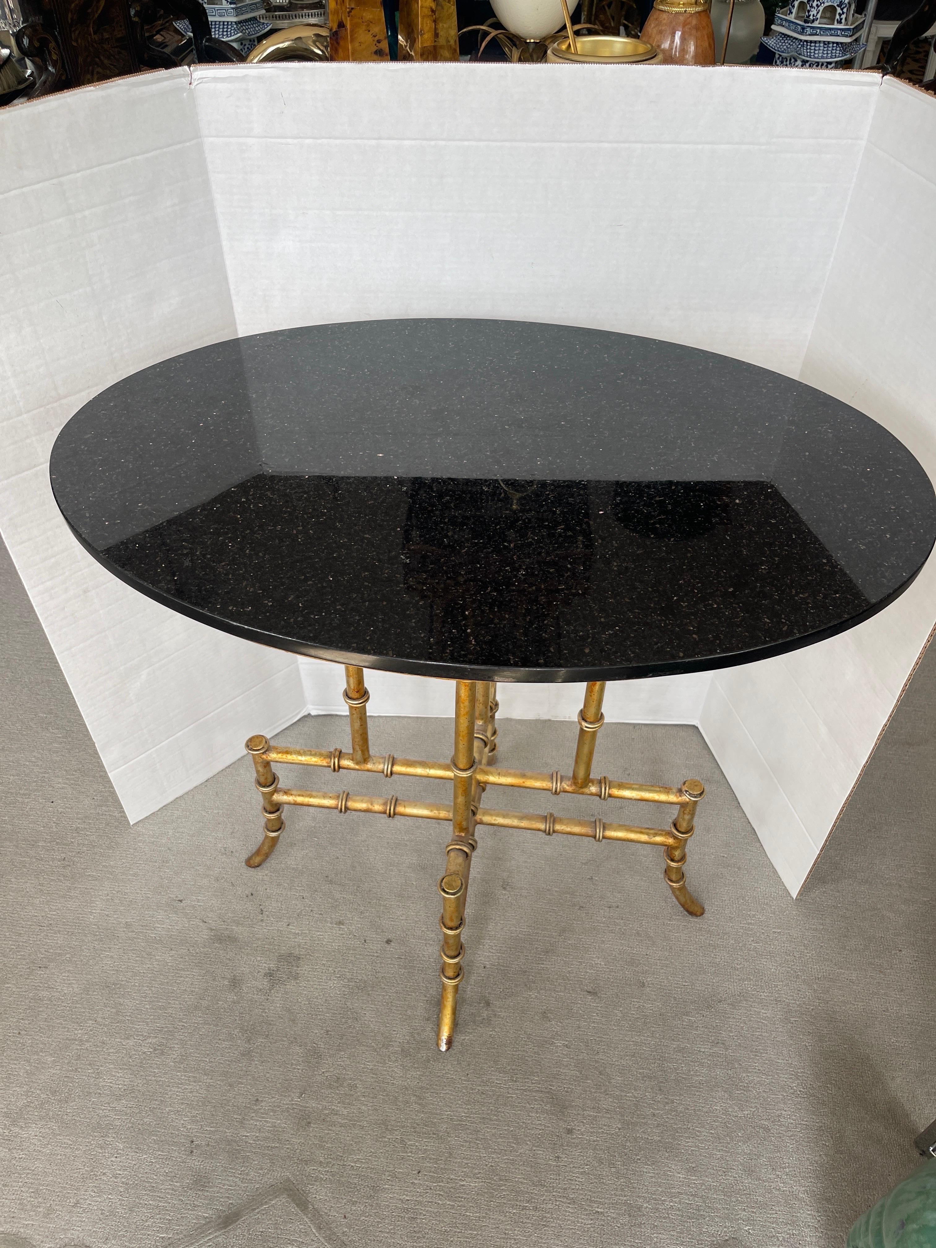 Just in, this beautiful gilt metal for bamboo side, table or center table with a black granite oval top.
This table could be Italian.
The granite top is not attached and sits a top of the base,  there are ridges under the granite to adjust the base