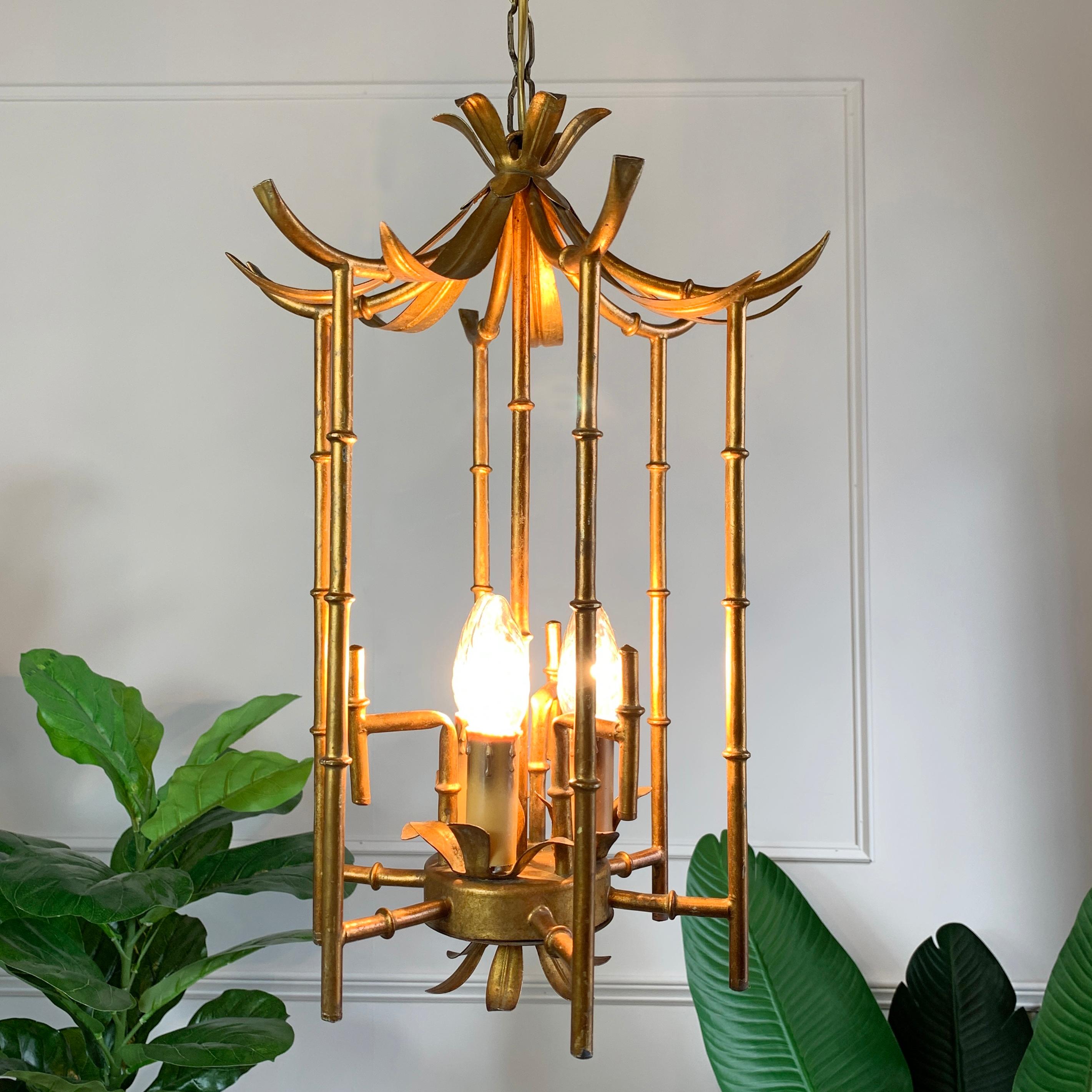 French 1960’s Chinoiserie faux bamboo chandelier, gilt metal in the form of a Pagoda. The lamp is very much in the manner of Maison Bagues, delicately detailed bamboo stemmed cage, surrounds three lamp holders that sit within the centre of the