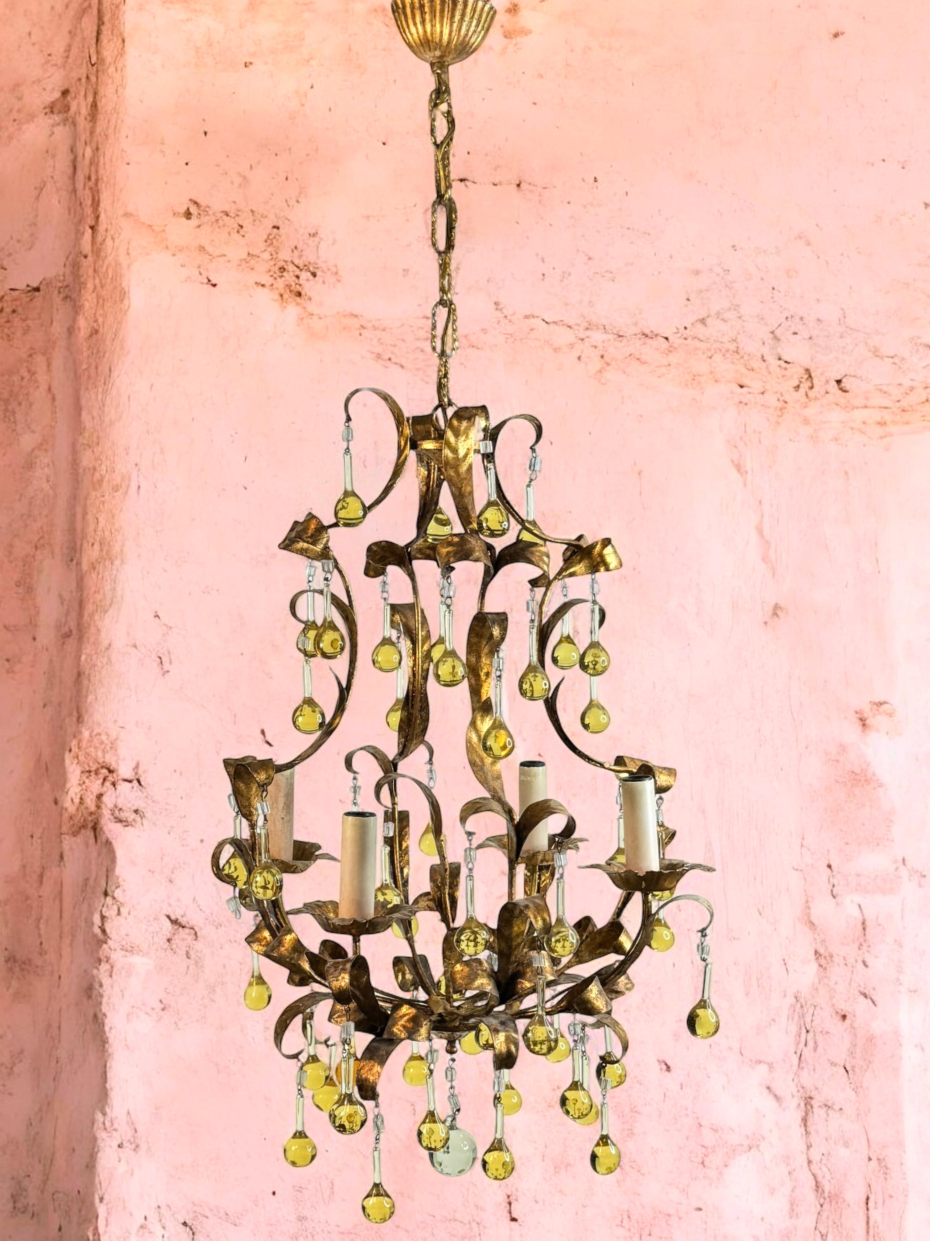 A Hollywood Regency midcentury gilt and tole water drop chandelier in Coco Chanel Style, the fixture requires four European E14 candelabra bulbs, each bulb up to 40 watts. Chandelier part itself is approx. 22.5 inches high, the Chain with canopy is