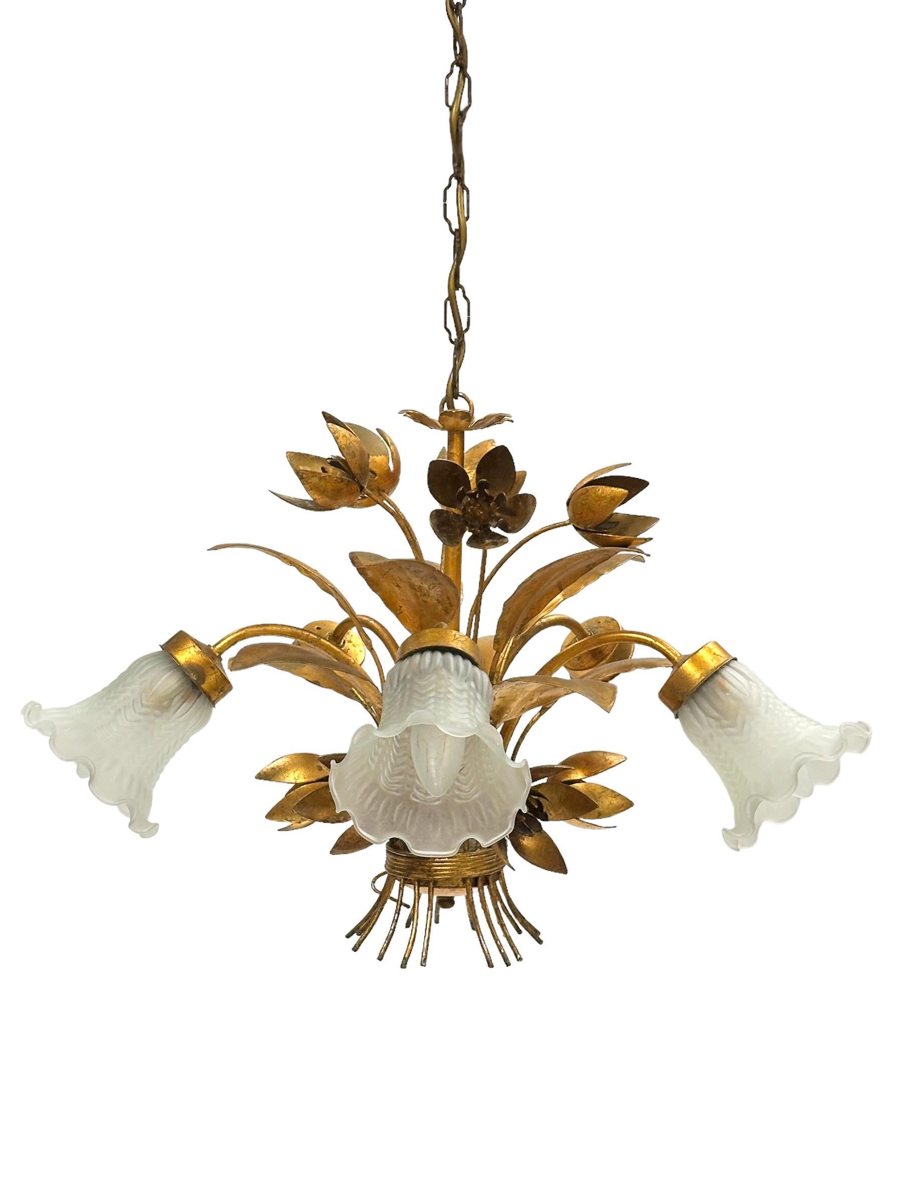 A Hollywood Regency midcentury gilt and tole bunch of flowers chandelier in Coco Chanel Style with beautiful glass shades, the fixture requires five European E14 candelabra bulbs, each bulb up to 40 watts. Chandelier part itself is approx. 17 inches