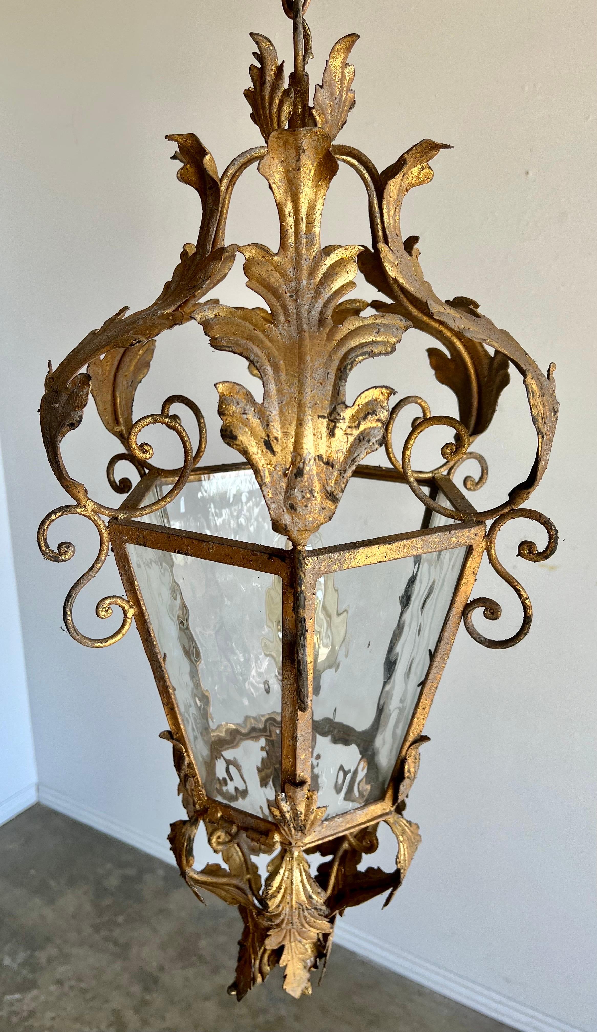 Italian gilt metal Lantern with original seeded glass. The lantern is newly rewired and includes chain and canopy.