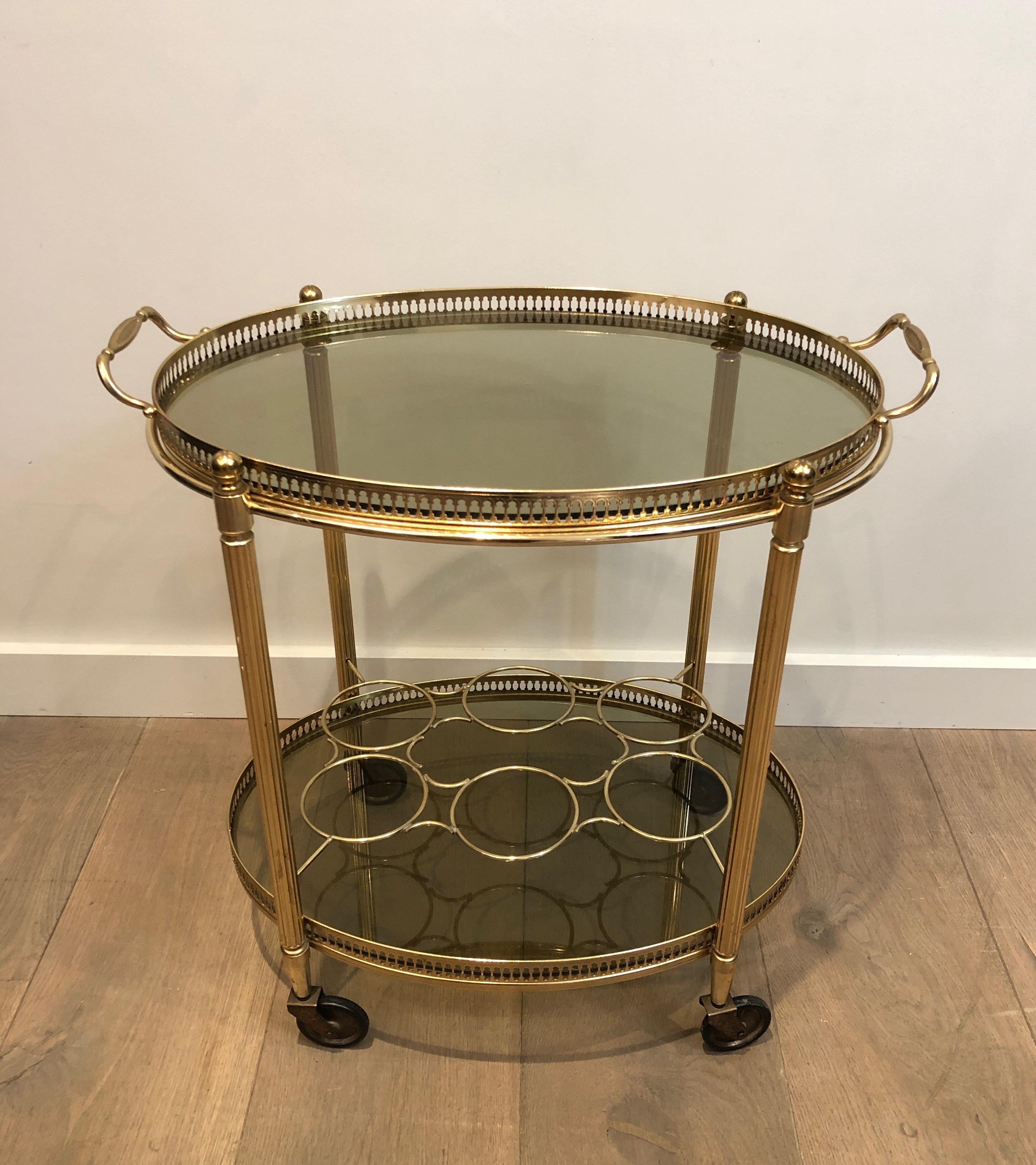 This oval drinks trolley is made of gilt metal with removable trays and bottles holder. This is a French work, circa 1940.