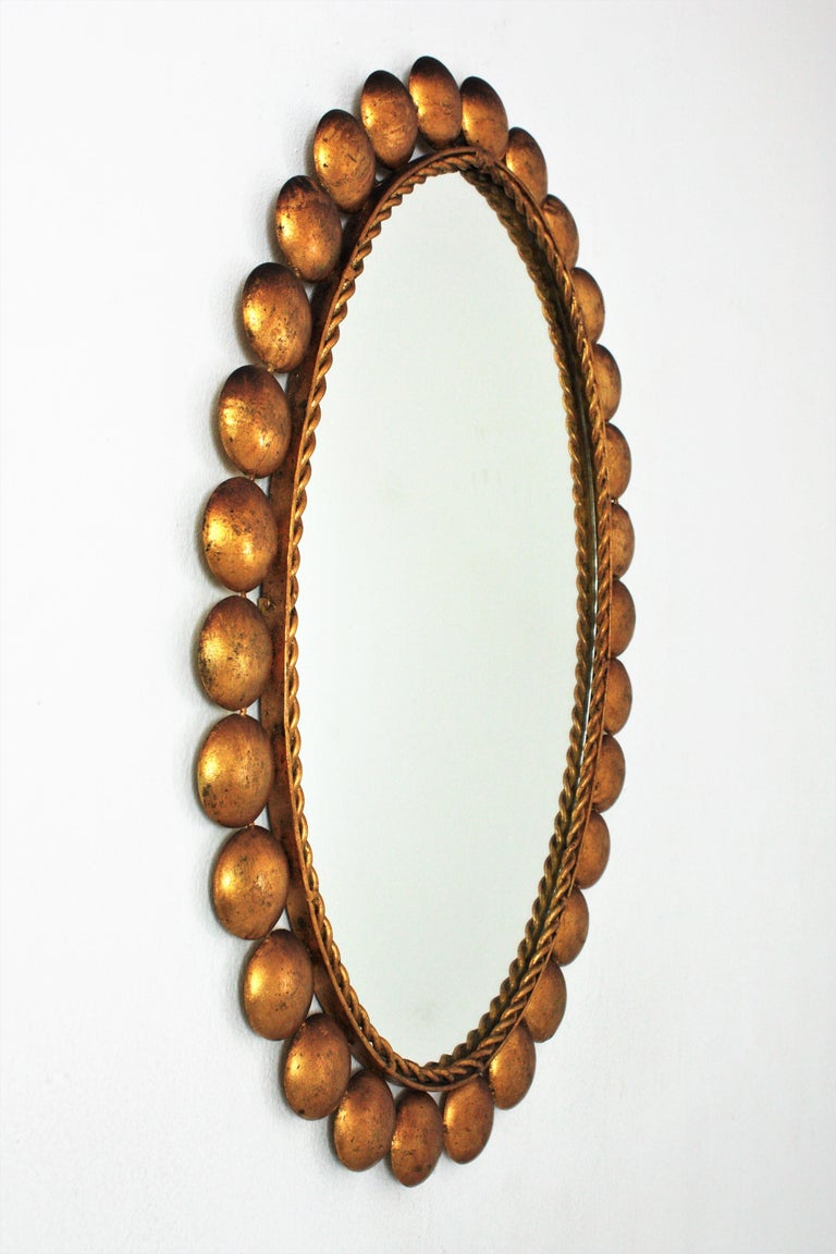 Gilt Metal Oval Mirror with Balls Frame For Sale at 1stDibs