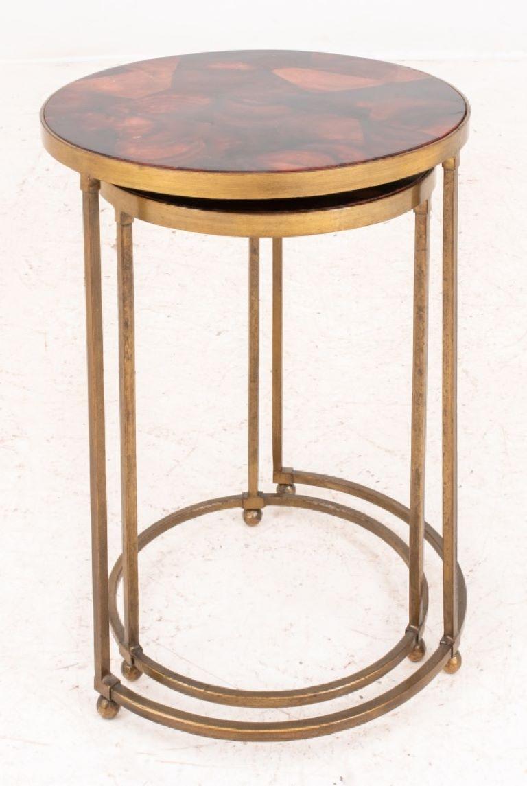 Gilt metal round nesting end tables, circular, both with unusual glazed ceramic patterned tops above conforming bases on ball feet.

Dealer: S138XX