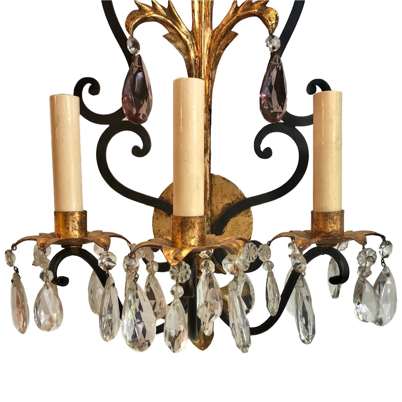 Pair of circa 1930’s French wrought iron sconces with gilt details and with amethyst crystal drops.

Measurements:
Height: 24″
Depth: 9″
Width: 12″