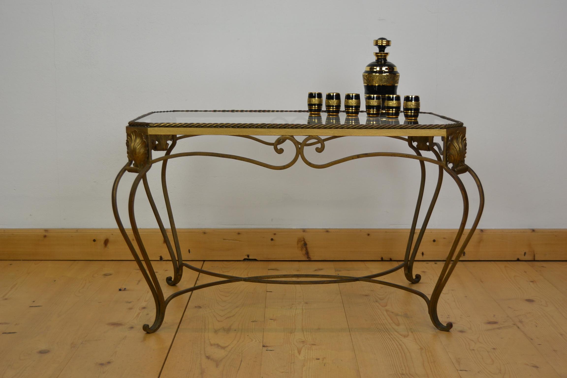 French gilt metal coffee table or side table.
A stylish table with ropes around the octagonal glass table top and shells or leaves on the corners. The bowed legs and the curling details make this side table very elegant.
Glass table top does have
