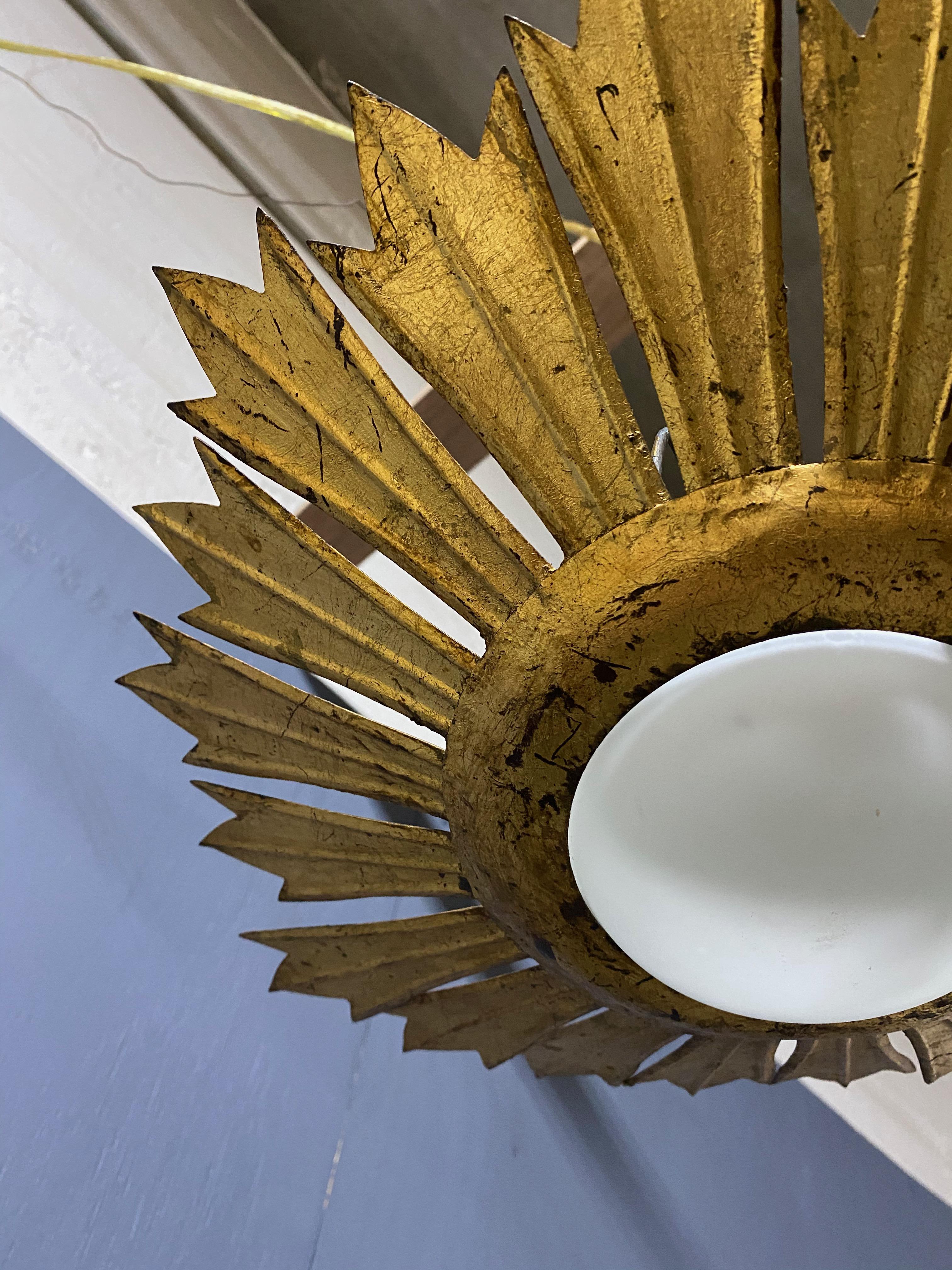 Spanish Gilt Metal Sunburst Ceiling Fixture with Convex Opaline Globe For Sale