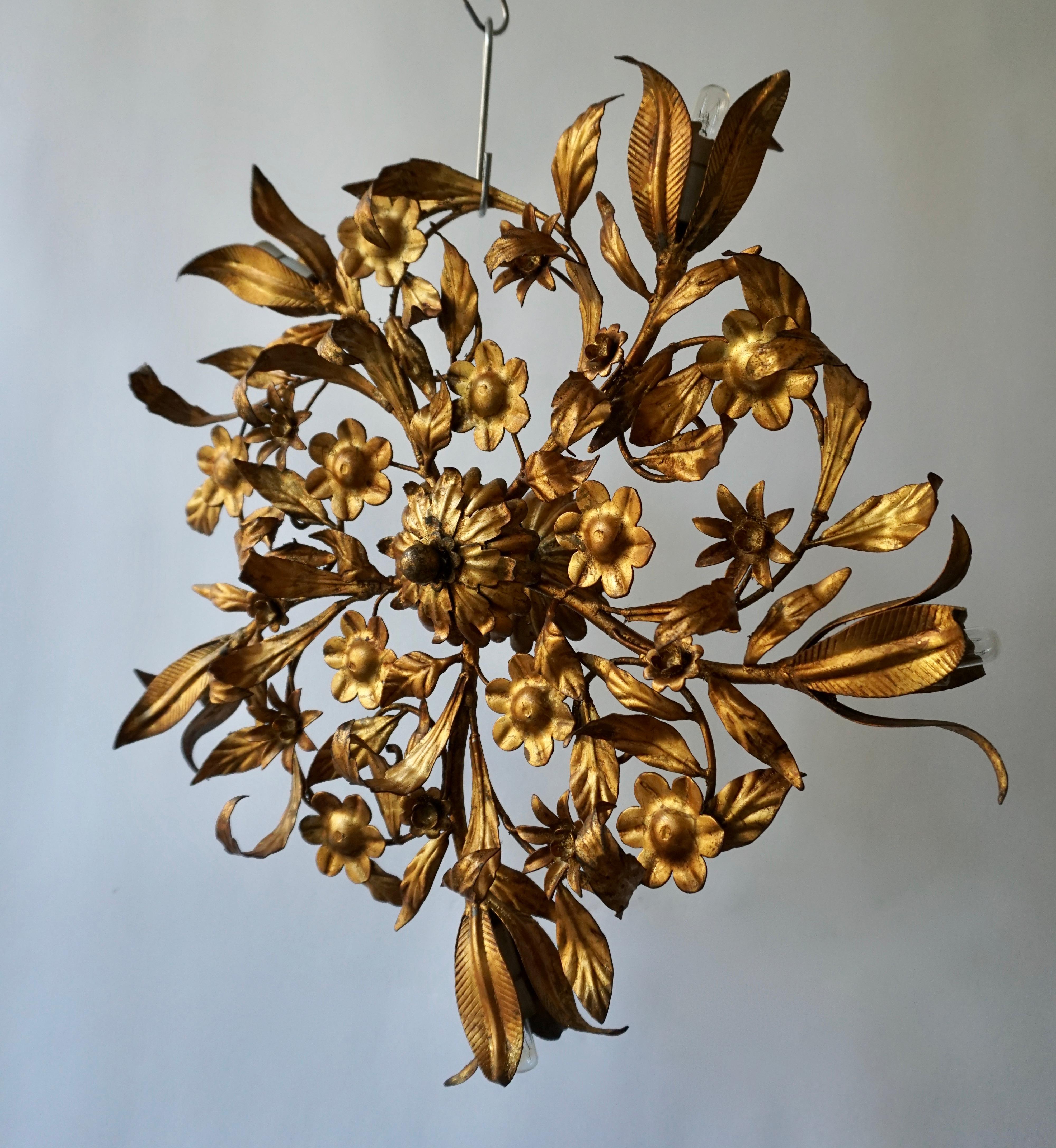 A circa 1950s Italian gilt metal sunburst shaped light fixture with tulip five-light.
The exquisite quality of this piece showcases the masterful skills of Ciani's craftsmen and offer an elegant sense of movement to any ceiling or wall.  

Bulb