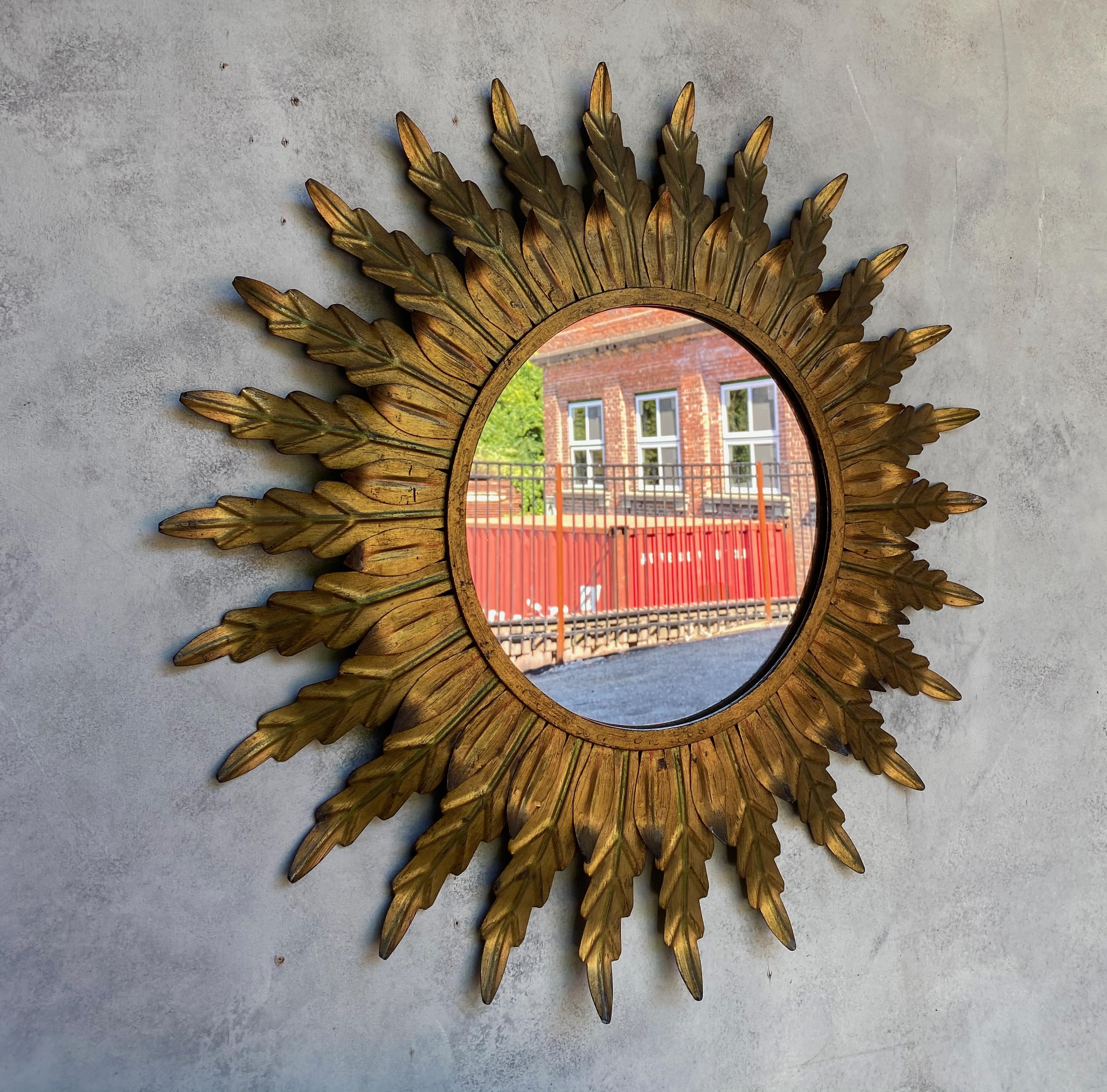 Mid-20th Century Gilt Metal Sunburst Mirror with Radiating Leaves and Traces of Green Hues