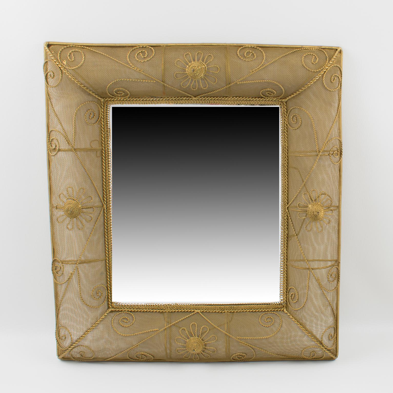 This elegant 1950s rectangular gilt metal wall-mounted mirror features interesting dimensional domed sides with raised detailing built with gilded metal mesh wire. You can position the mirror in portrait or landscape orientation, thanks to two hooks