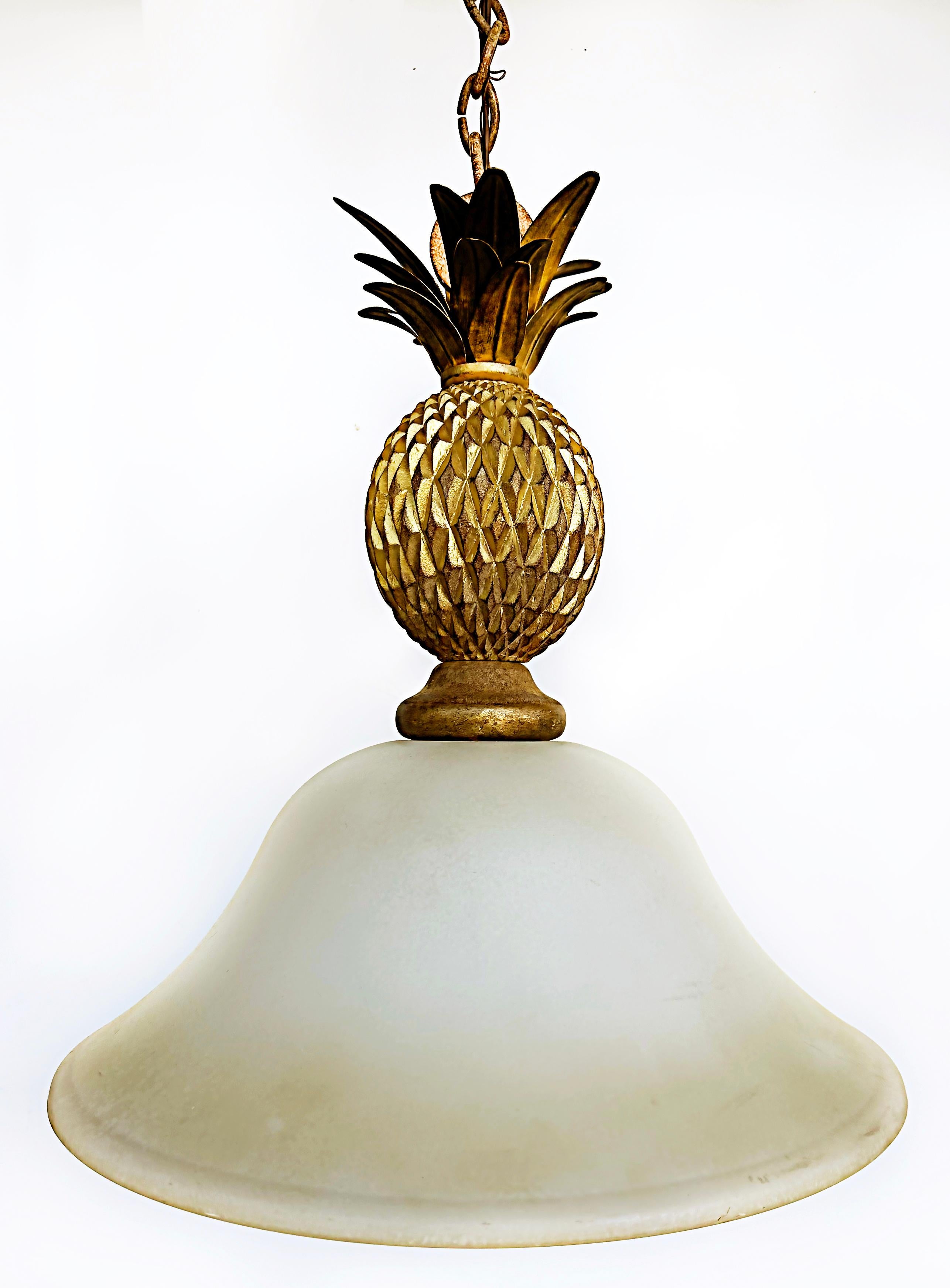 Gilt metal wood pineapple glass pendant ceiling fixture with chain.

Offered for sale is a gilt metal and carved wood pineapple pendant light ceiling fixture with a frosted glass shade. The ceiling fixture is supported with a chain that can be
