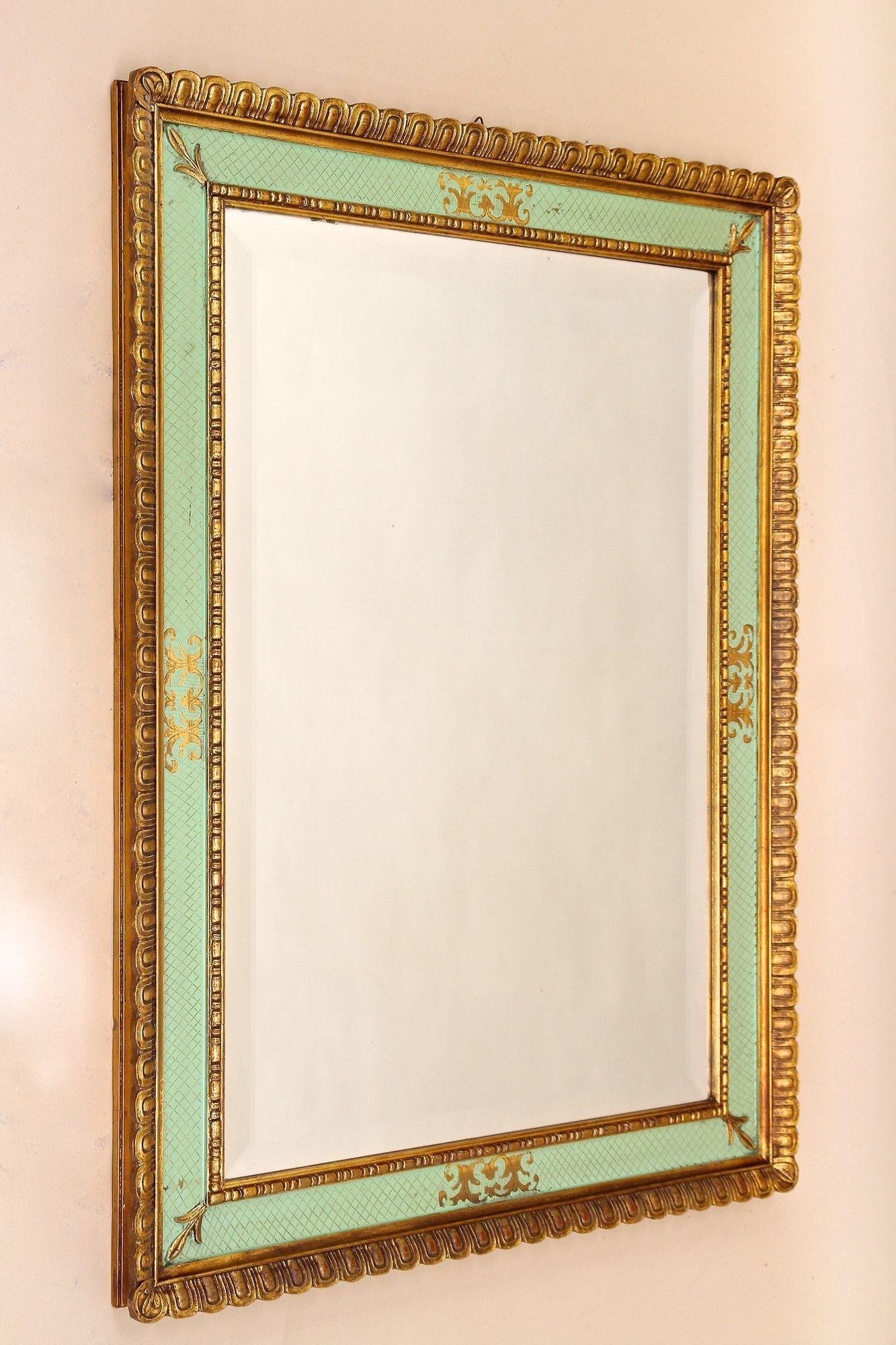 Highly decorative gilt Italian wall mirror from the 1960s in Venice. A truly eyecatching, large wall mirror from the mid century period, designed after the famous Venetian frames from the 18th century. This luxurious vintage mirror impresses with
