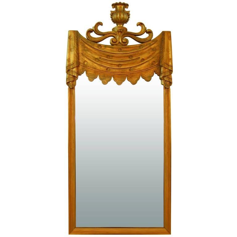 A decorative carved gilt mirror by Grosfeld House.

American, circa 1940s.

In stock.