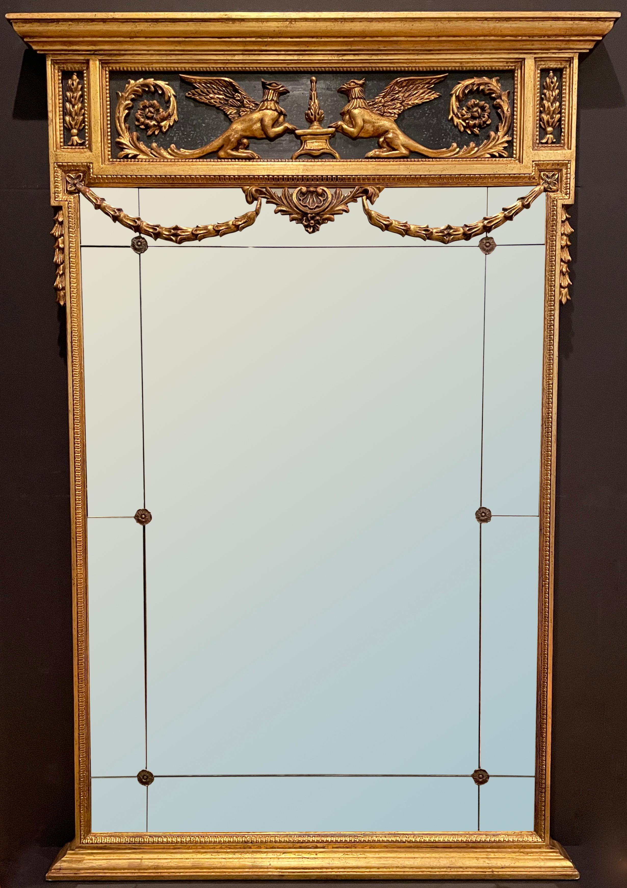 Fine quality carved and gilt mirror by La Barge with original label. Mirrored panels with rosettes and hanging garland. Raised carved flanking griffin's in and ebonized panel.