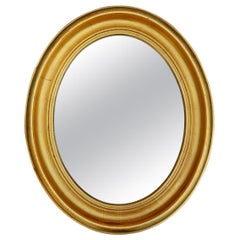 Miroir à cadre ovale doré
