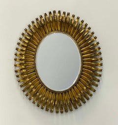 Espejo de pestañas de metal ovalado dorado con bisel