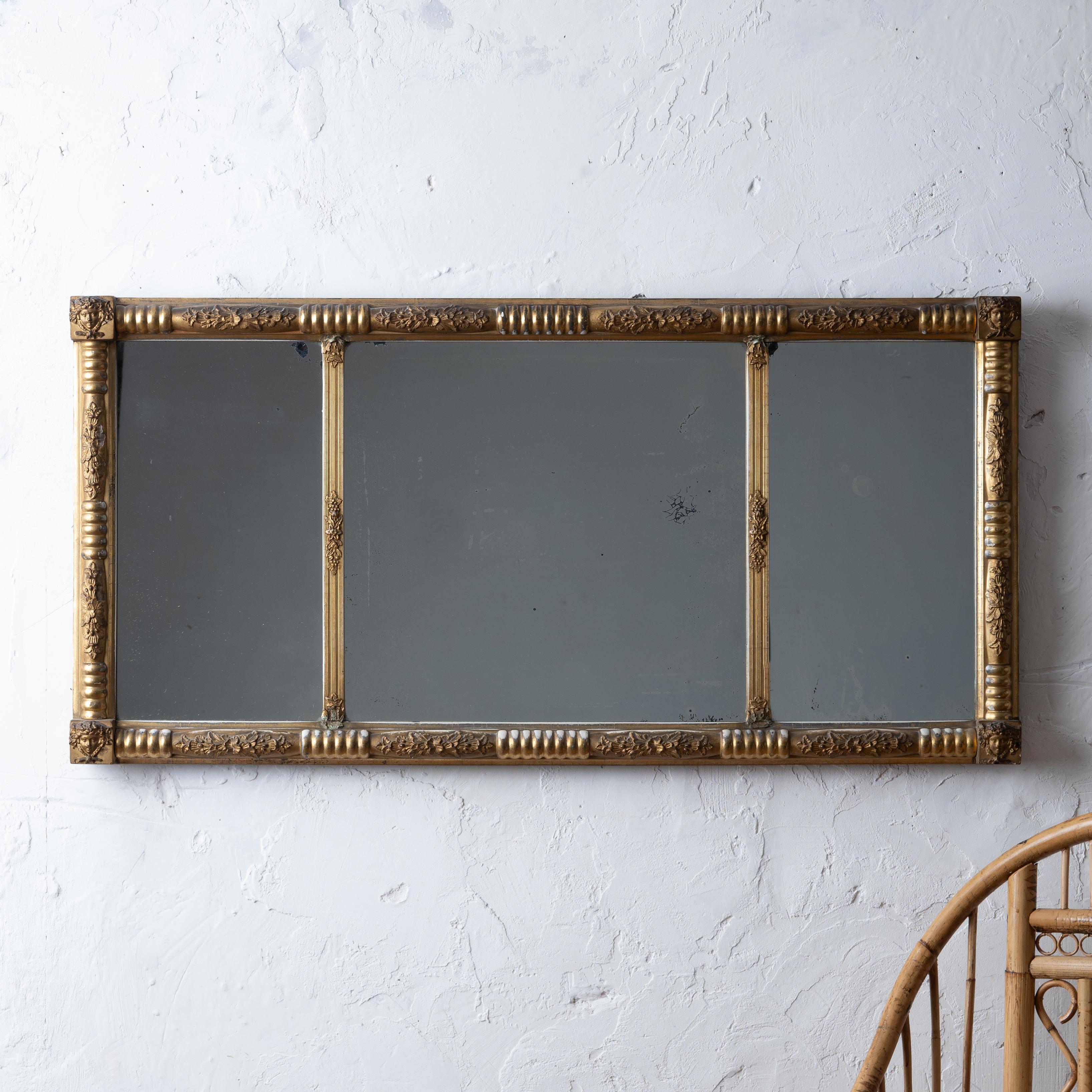 A gilt overmantel mirror, mid-19th century.
Featuring a split baluster frame with figural bacchante corner blocks and divided mirror plate.

43 ½ by 21 ½ inches


