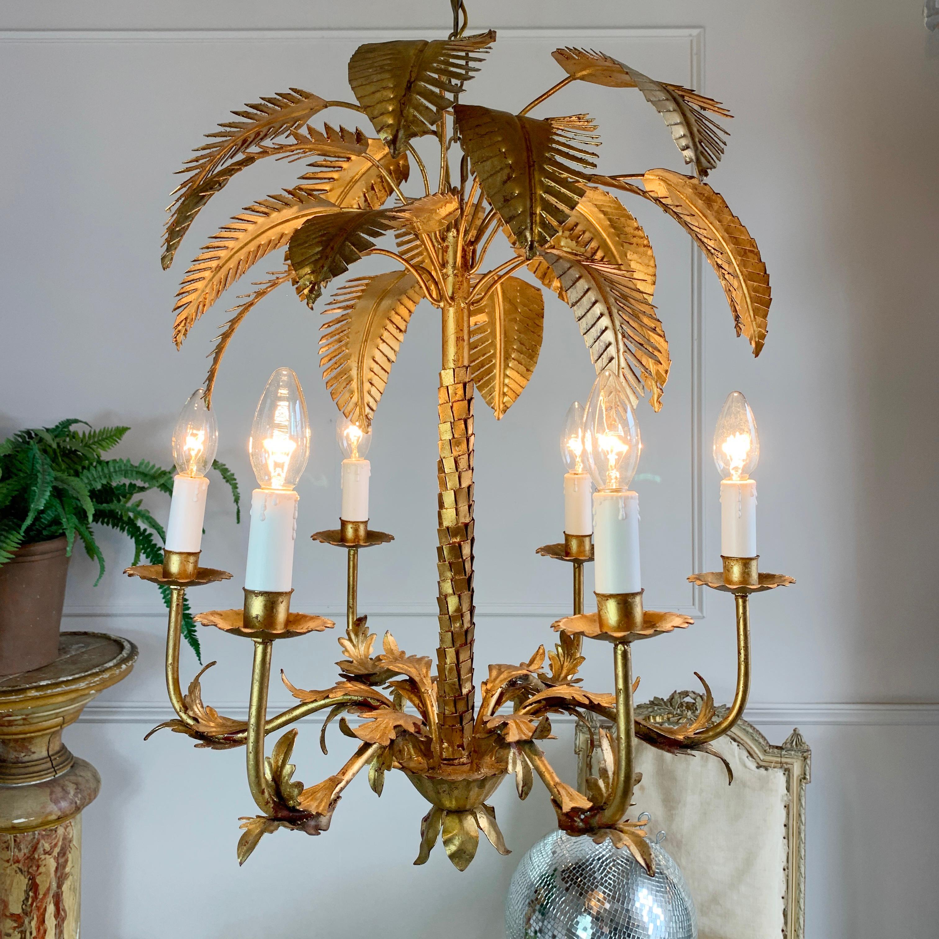 This stunning gilt palm leaf chandelier from the 1960’s is a masterclass in nature inspired lighting. 

The central stem is created to replicate the bark of the tree, whilst the individually formed leaves spring from the top to create a striking