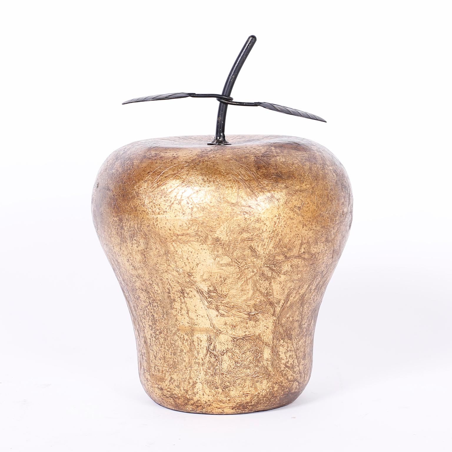 Large sculptural apple and pear crafted in porcelain and decorated with textured gold leaf with metal leaves. Priced individually. 

Apple measures: H 13, DM 9

Pear measures: H 16, DM 9.
