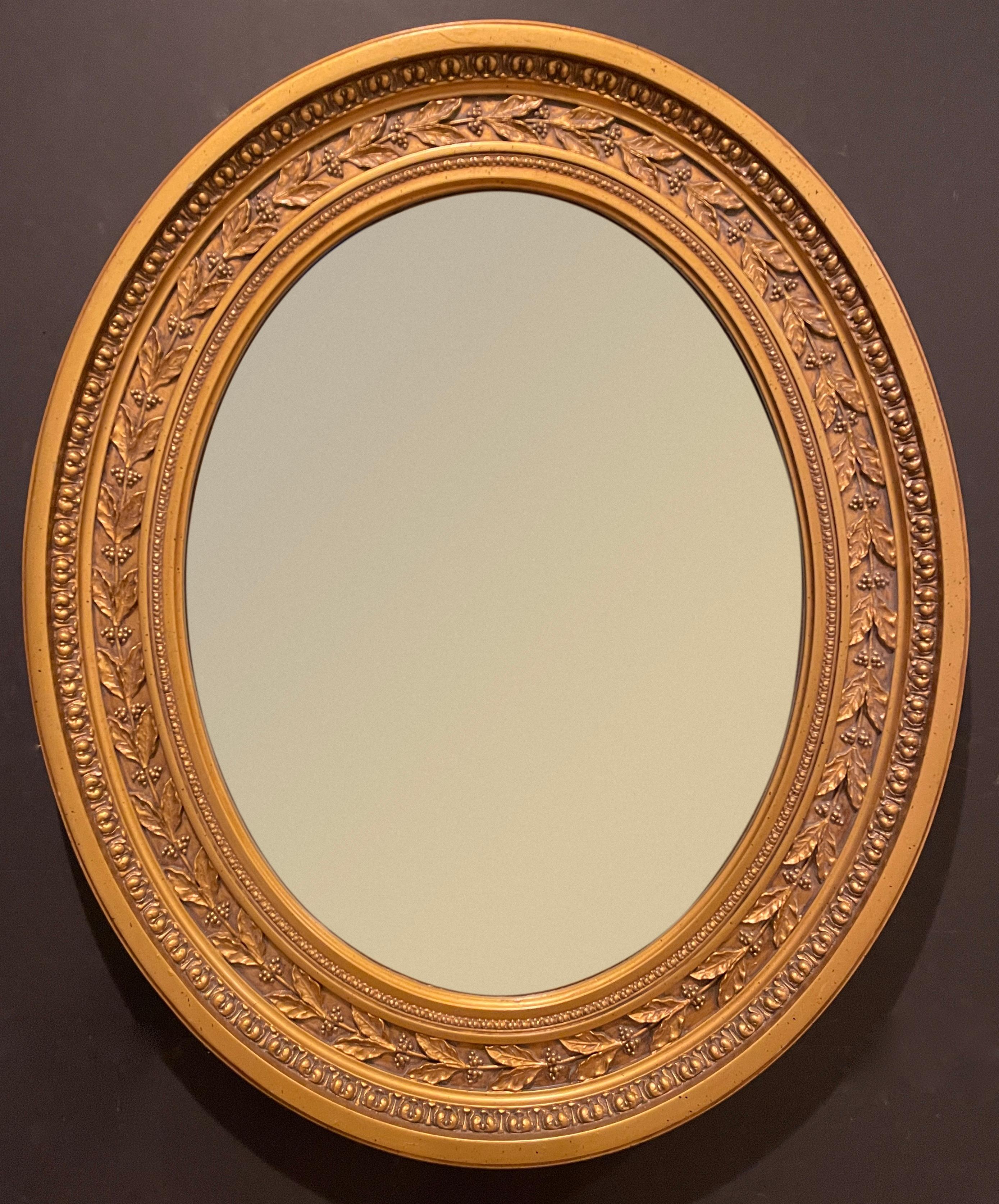Gilt oval frame in the Regency style with nice modeling of laurel leaves and berries with additional moulding element of a type of egg and dart motif.